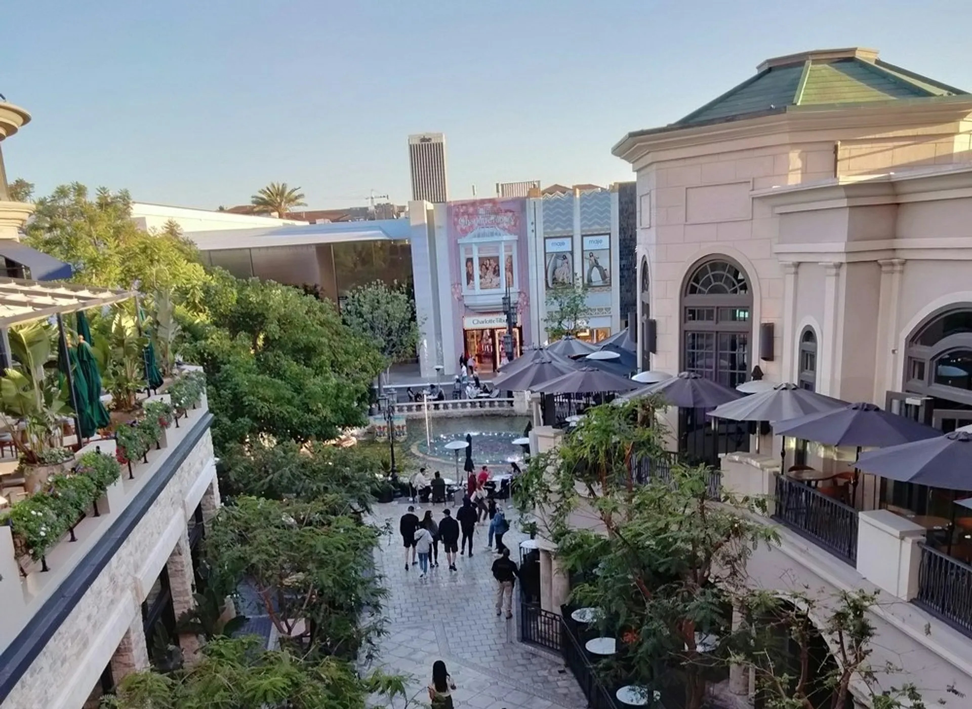 An upscale outdoor shopping area with restaurants and a small crowd, located at The Grove in Los Angeles.