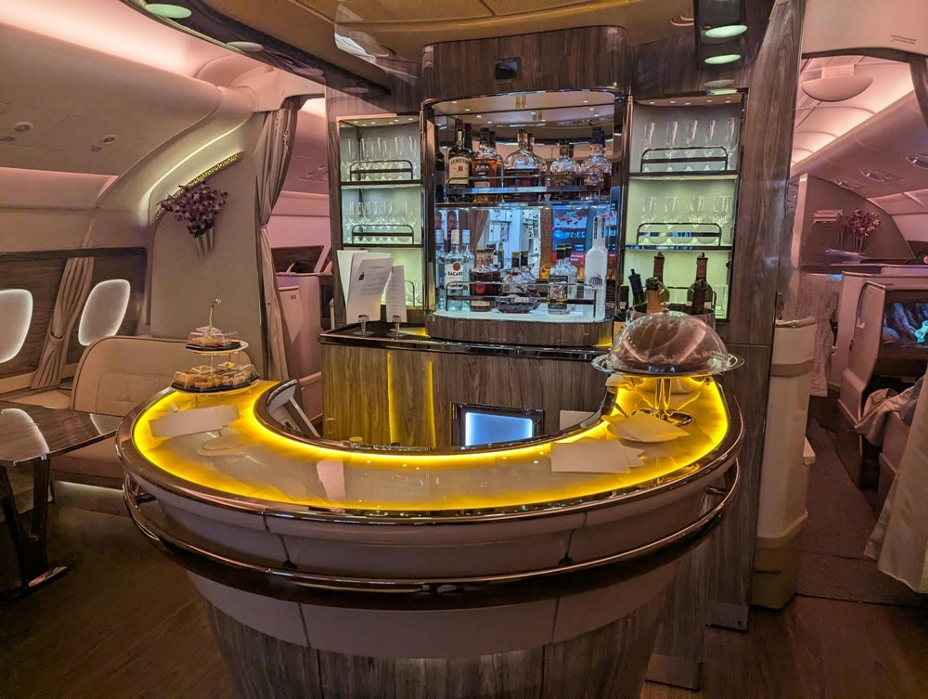 Luxurious onboard bar in the business class section of an Emirates A380 aircraft.
