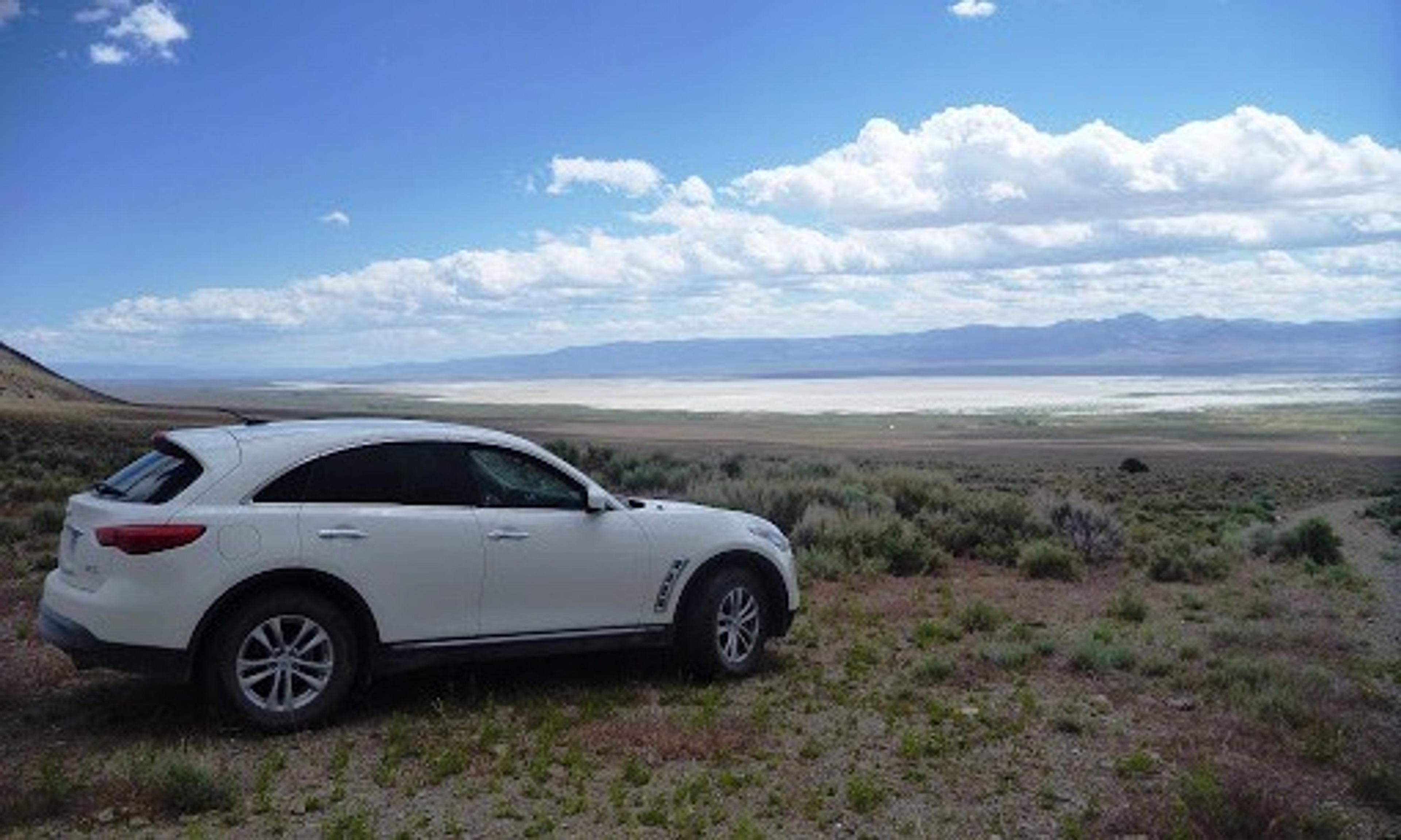 White car overlooking a bay