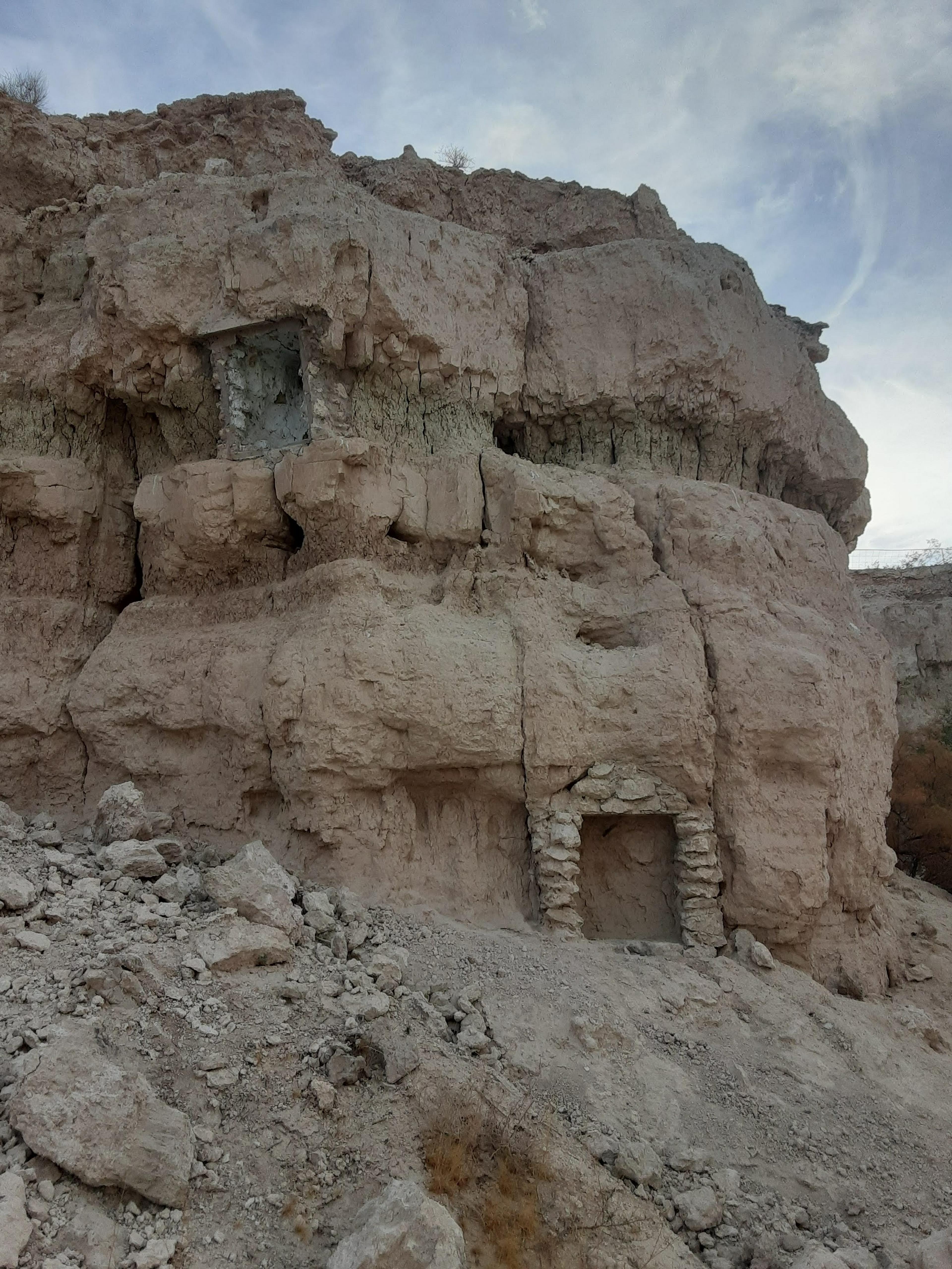Rocky cliffside with decaying brick shrines