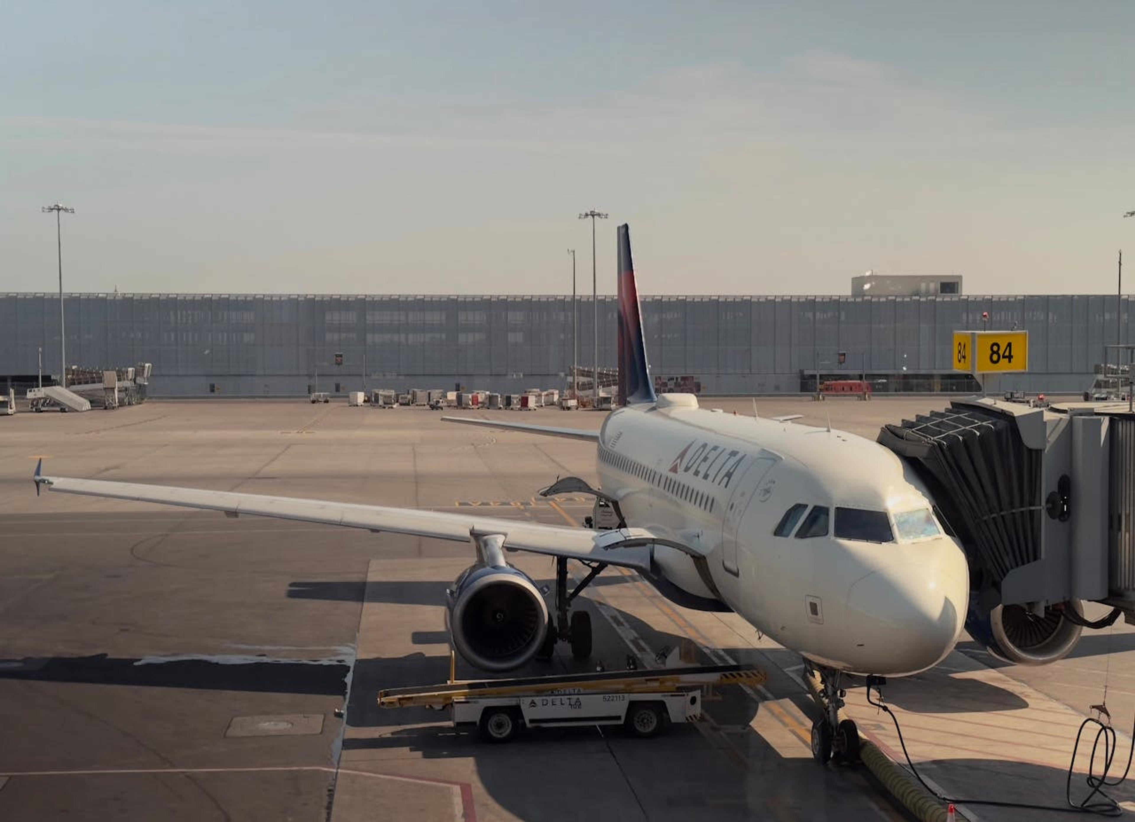 A Delta plane is parked at a gate at YUL airport.