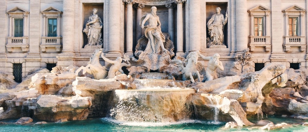 The Trevi Fountain in Rome features majestic sculptures and cascading water. Italy