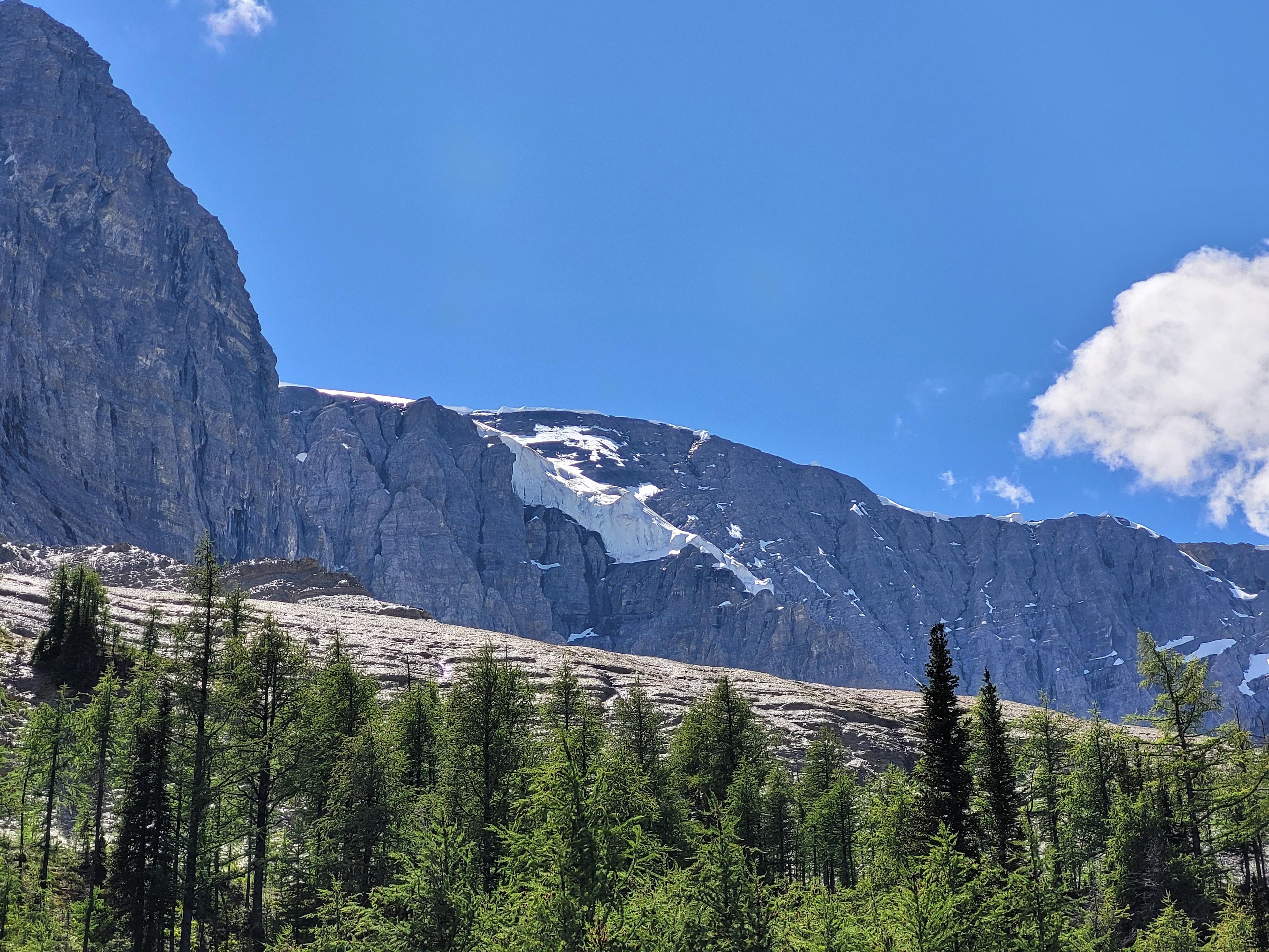 A rugged, snow-dusted mountain landscape in Banff National Park, Alberta, Canada.