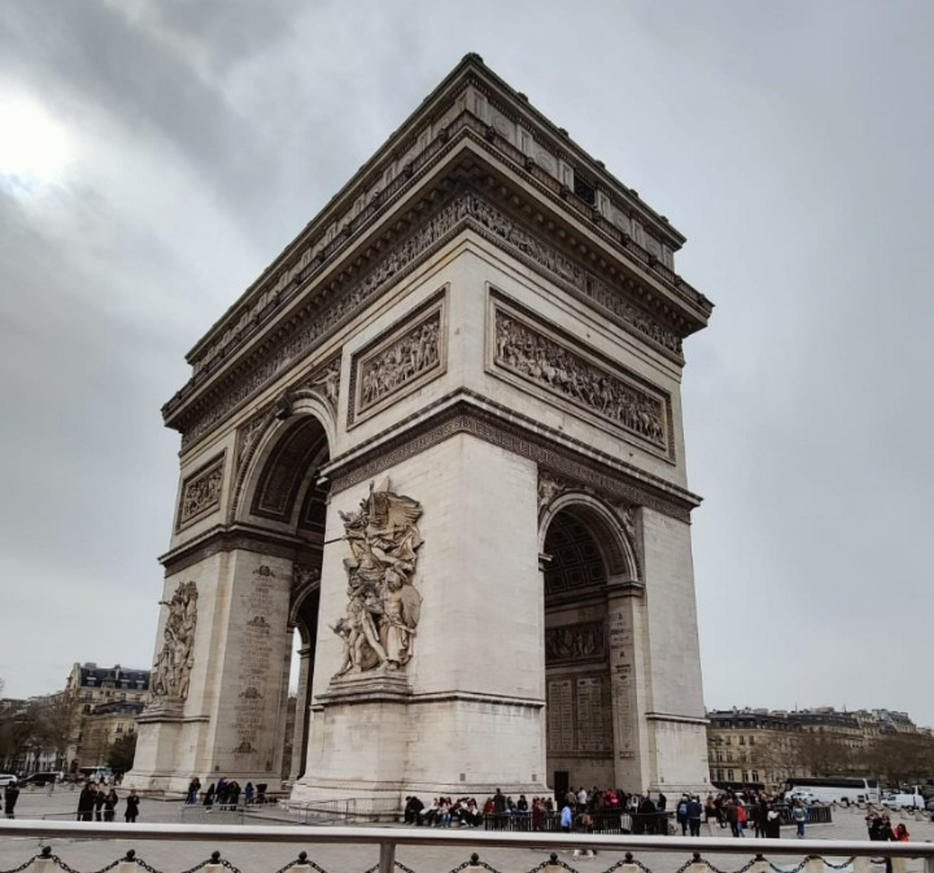 Visitors gather around the iconic Arc de Triomphe in Paris.