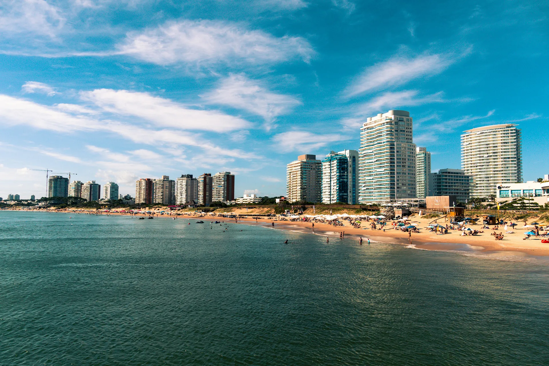 A bustling beach bordered by modern high-rise buildings in Punta del Este, Uruguay.