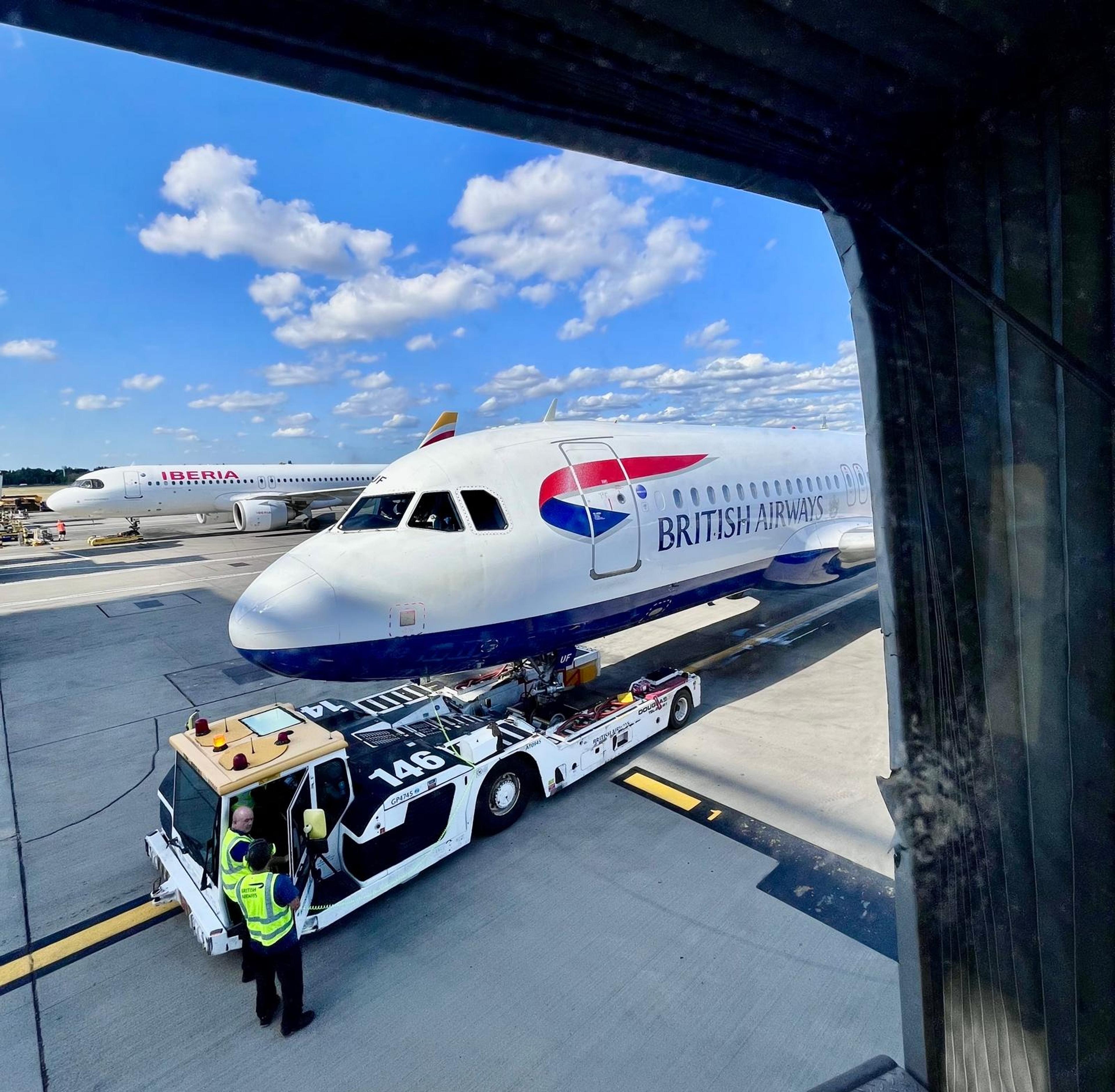 A British Airways plane is being towed on the tarmac