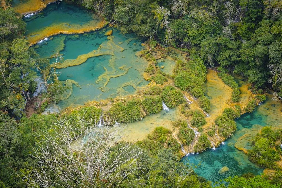 Turquoise pools cascade through lush greenery at Semuc Champey, Guatemala.