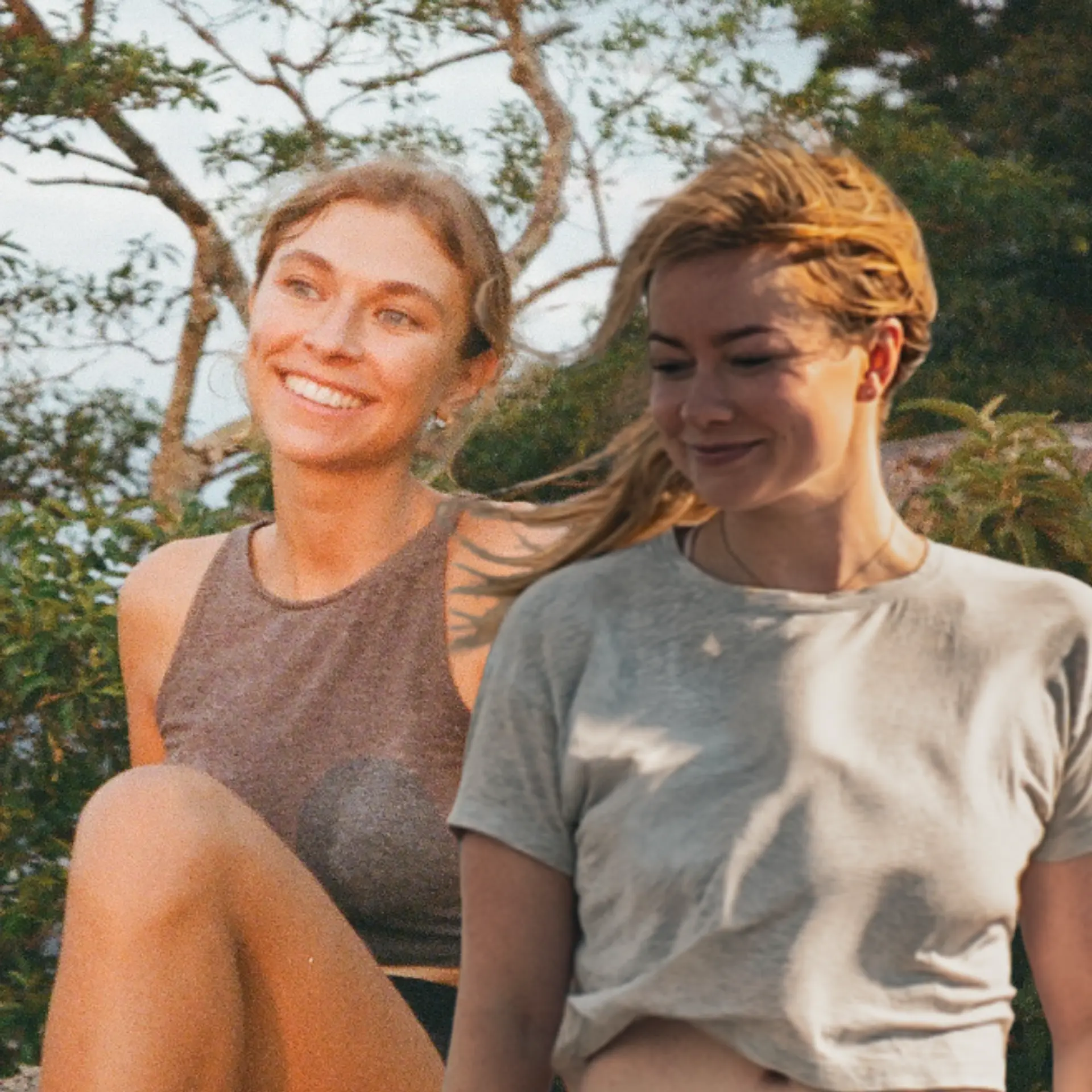 Two people stand outdoors amidst lush greenery, creating a vibrant and lively atmosphere.