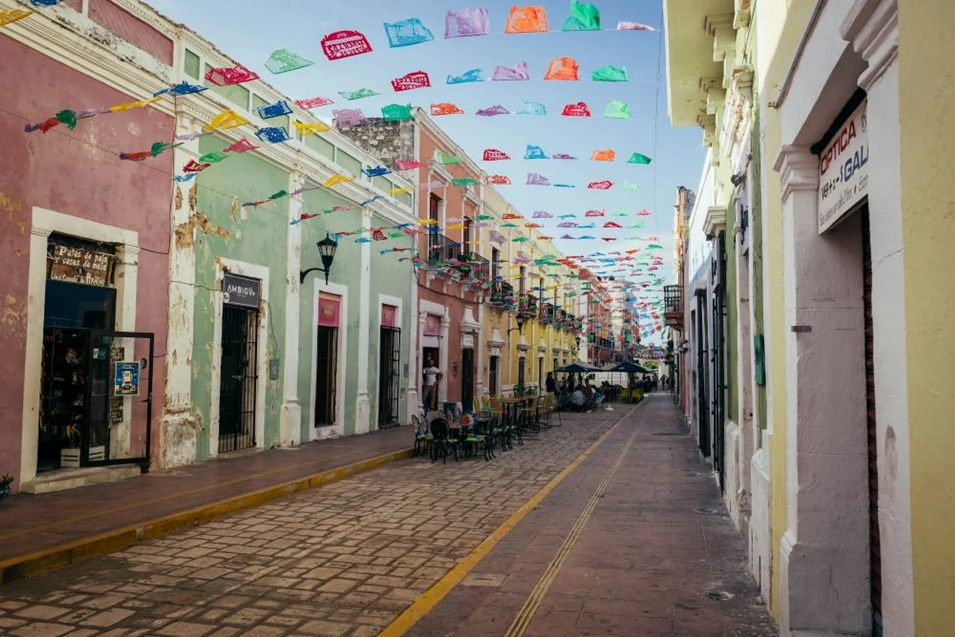 Colorful papel picado decorates a charming street in the historic center of Campeche, Mexico.
