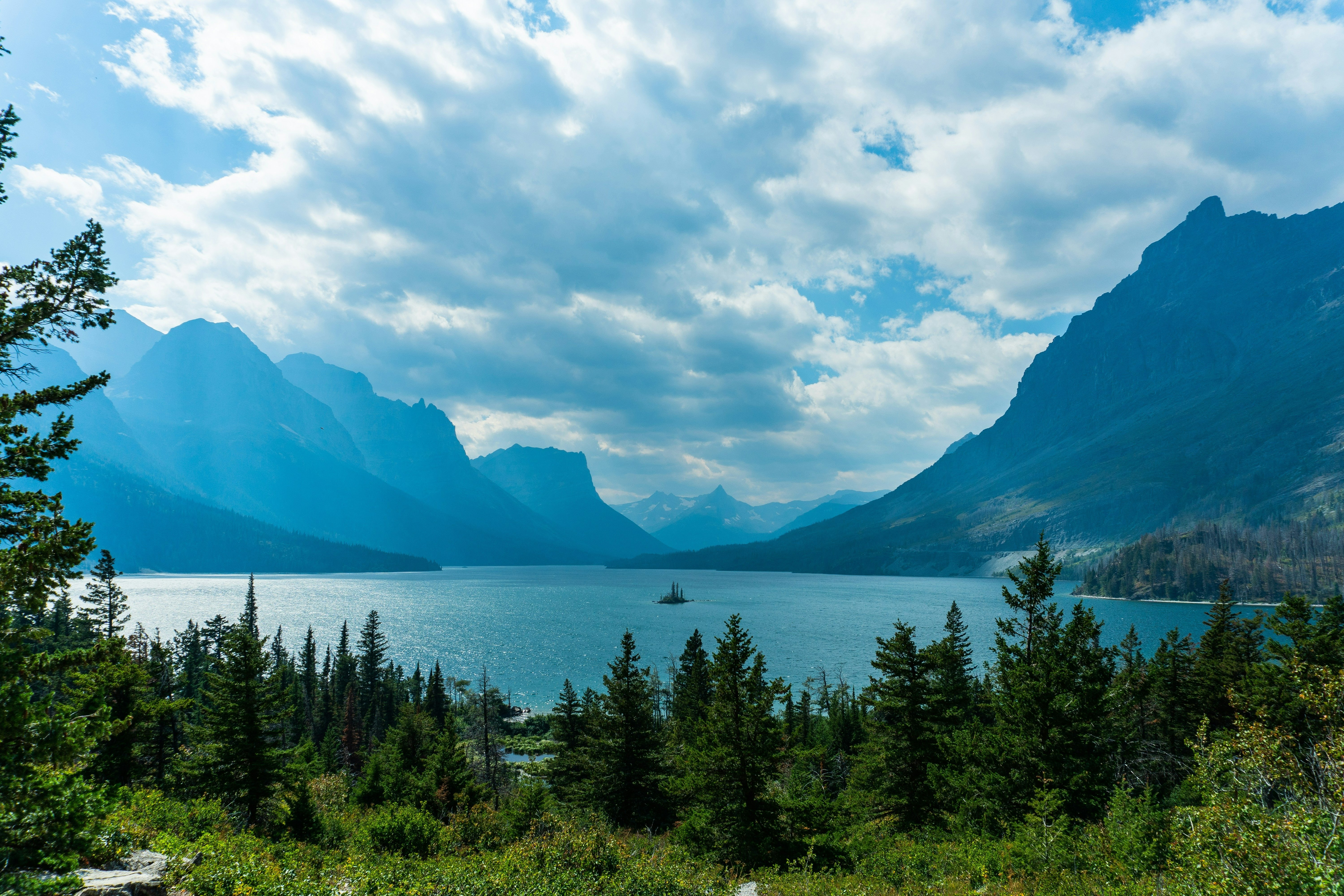 A breathtaking view of St. Mary Lake in Glacier National Park, Montana, framed by majestic mountains and dense forest.