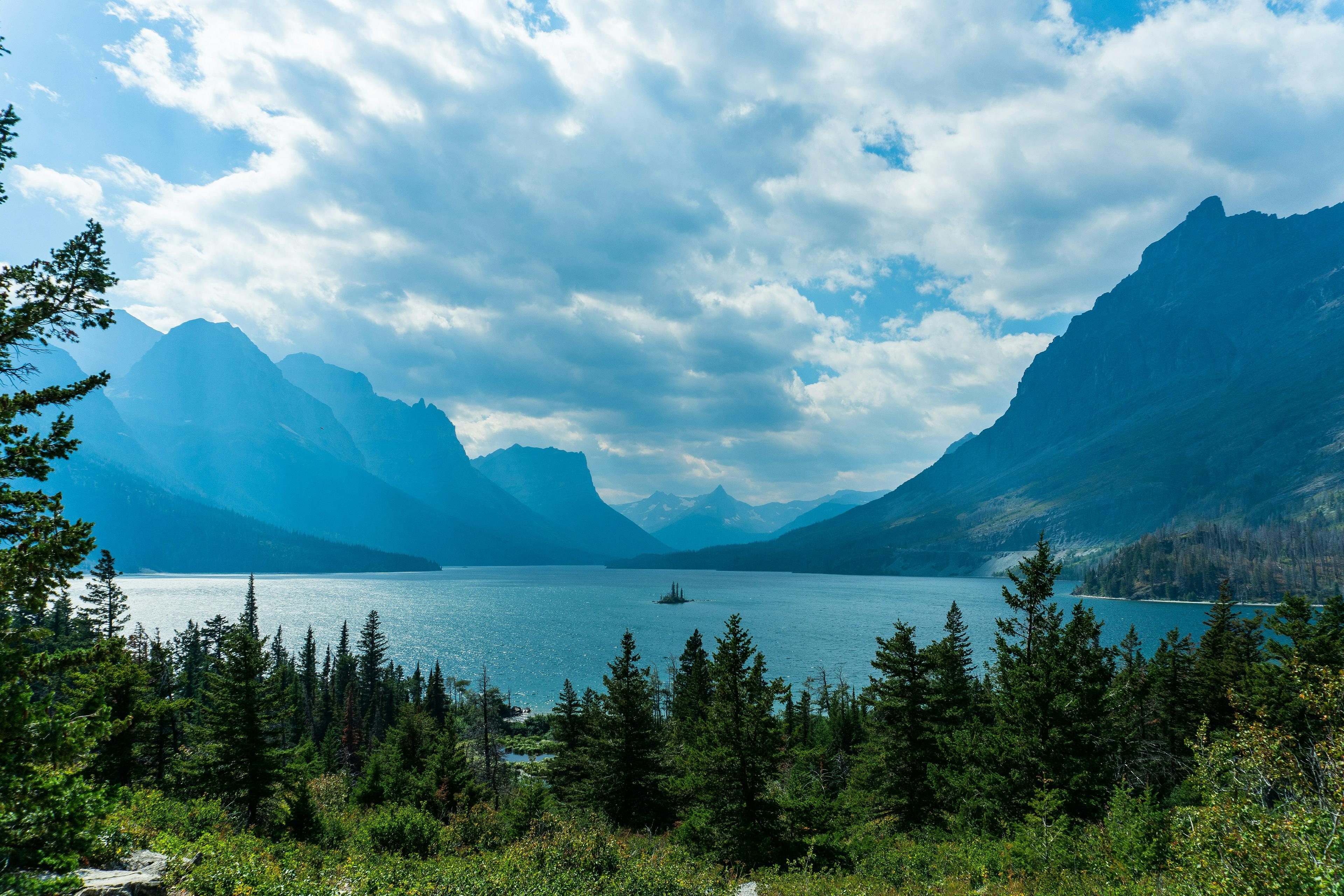 A breathtaking view of St. Mary Lake in Glacier National Park, Montana, framed by majestic mountains and dense forest.