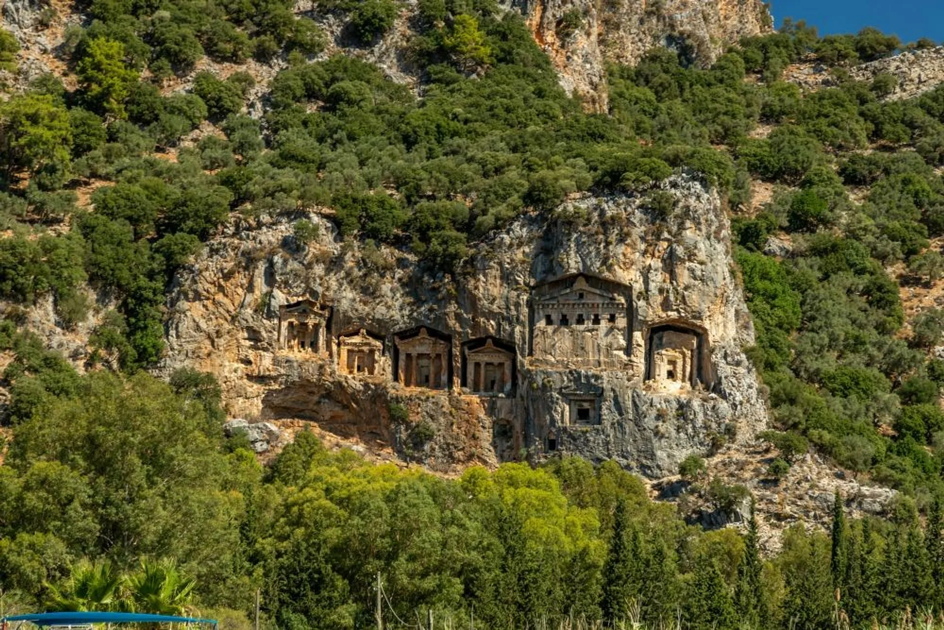 Rock-cut tombs overlook the lush landscape in Dalyan, Turkey.