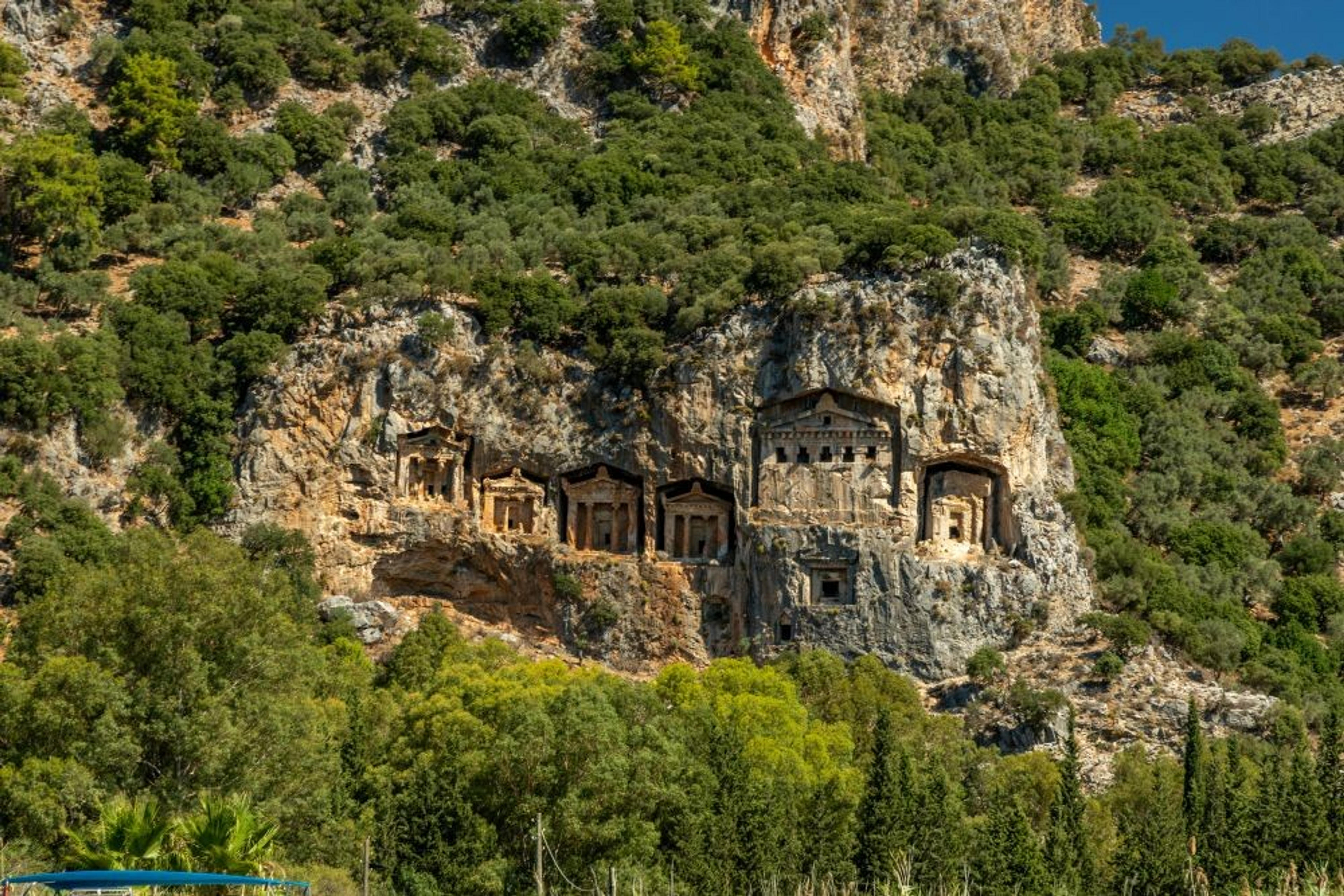 Rock-cut tombs overlook the lush landscape in Dalyan, Turkey.