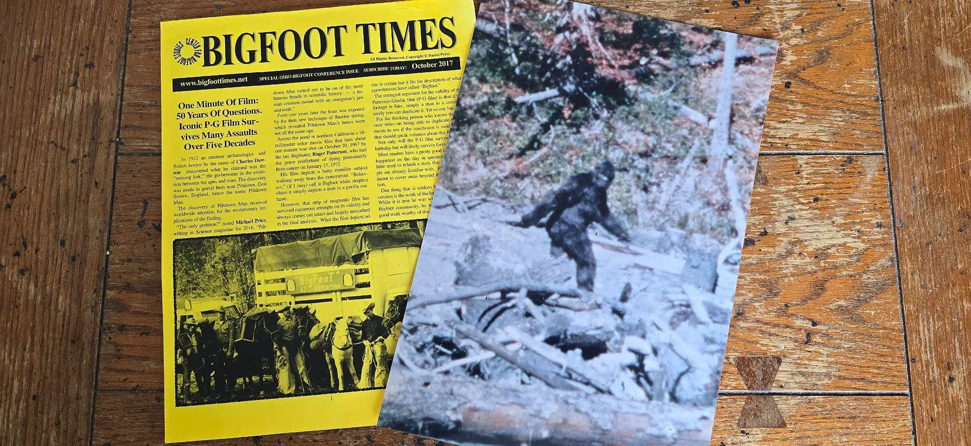 A yellow issue of "Bigfoot Times" from October 2017, alongside a photograph of the purported Bigfoot.