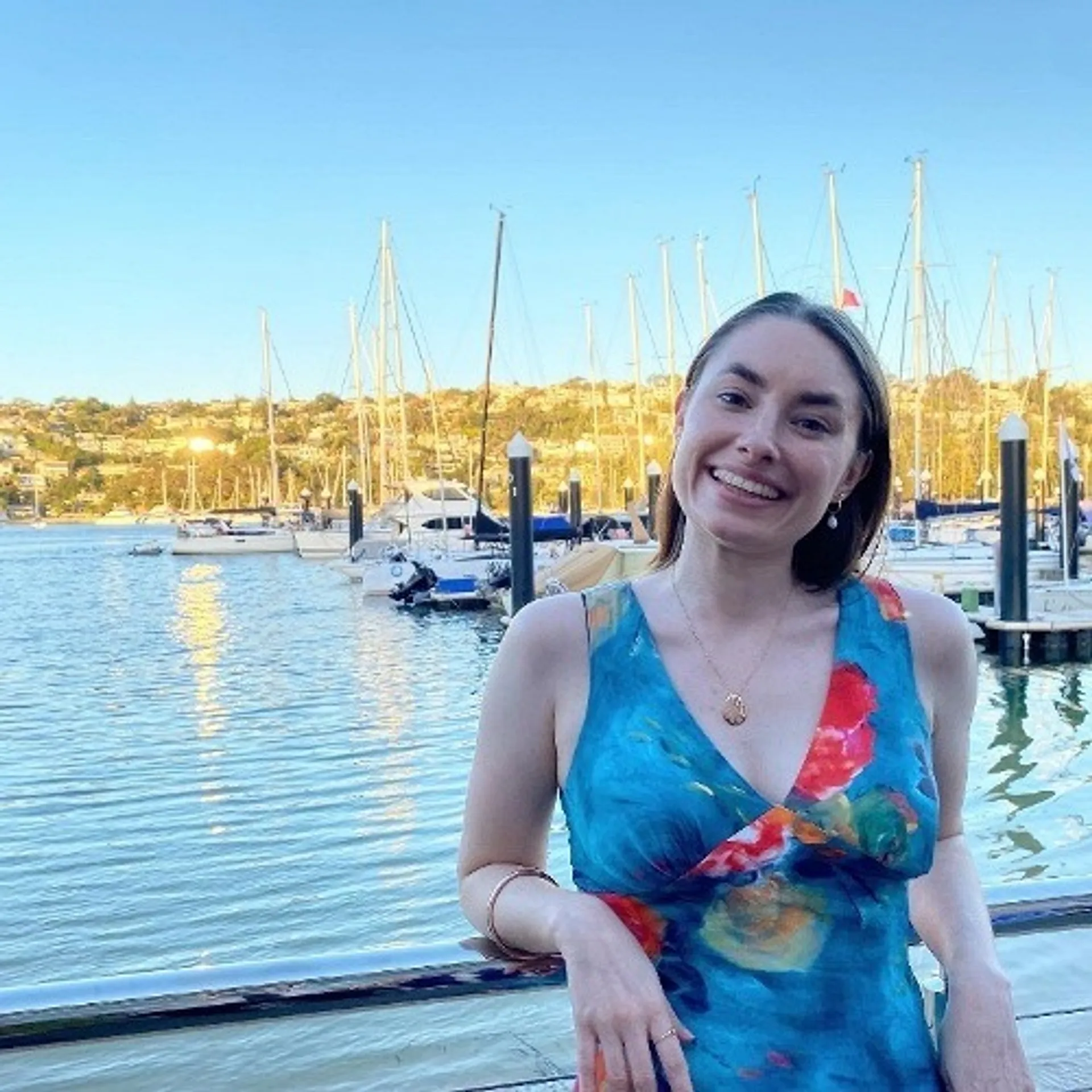 Larissa standing in front of a marina