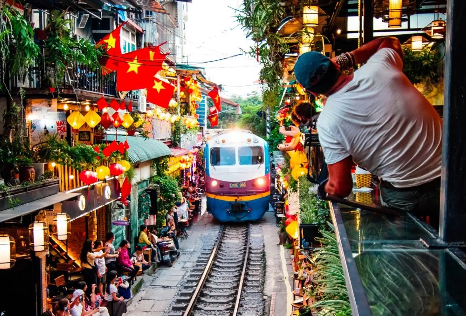 Train travelling along a narrow street in Vietnam