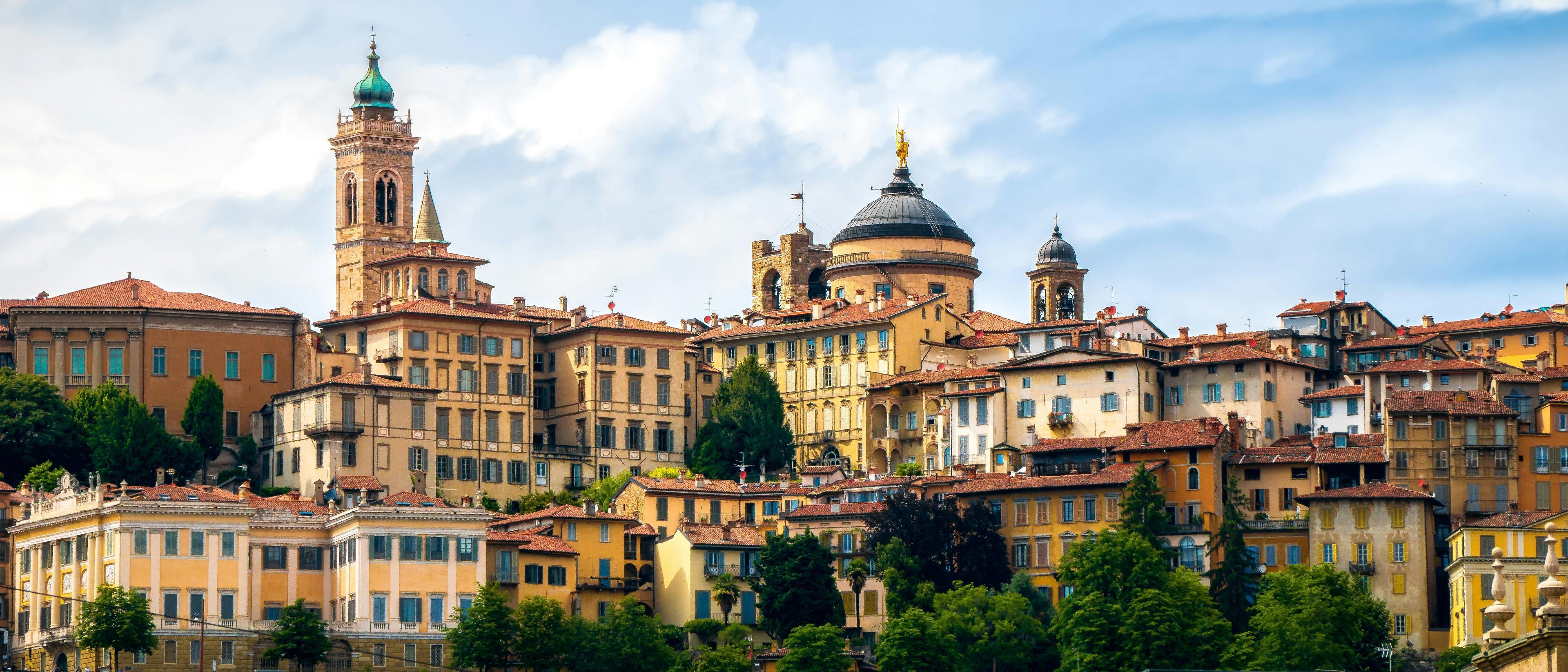 A picturesque view of Città Alta in Bergamo, Italy, featuring charming historic buildings and a prominent bell tower.