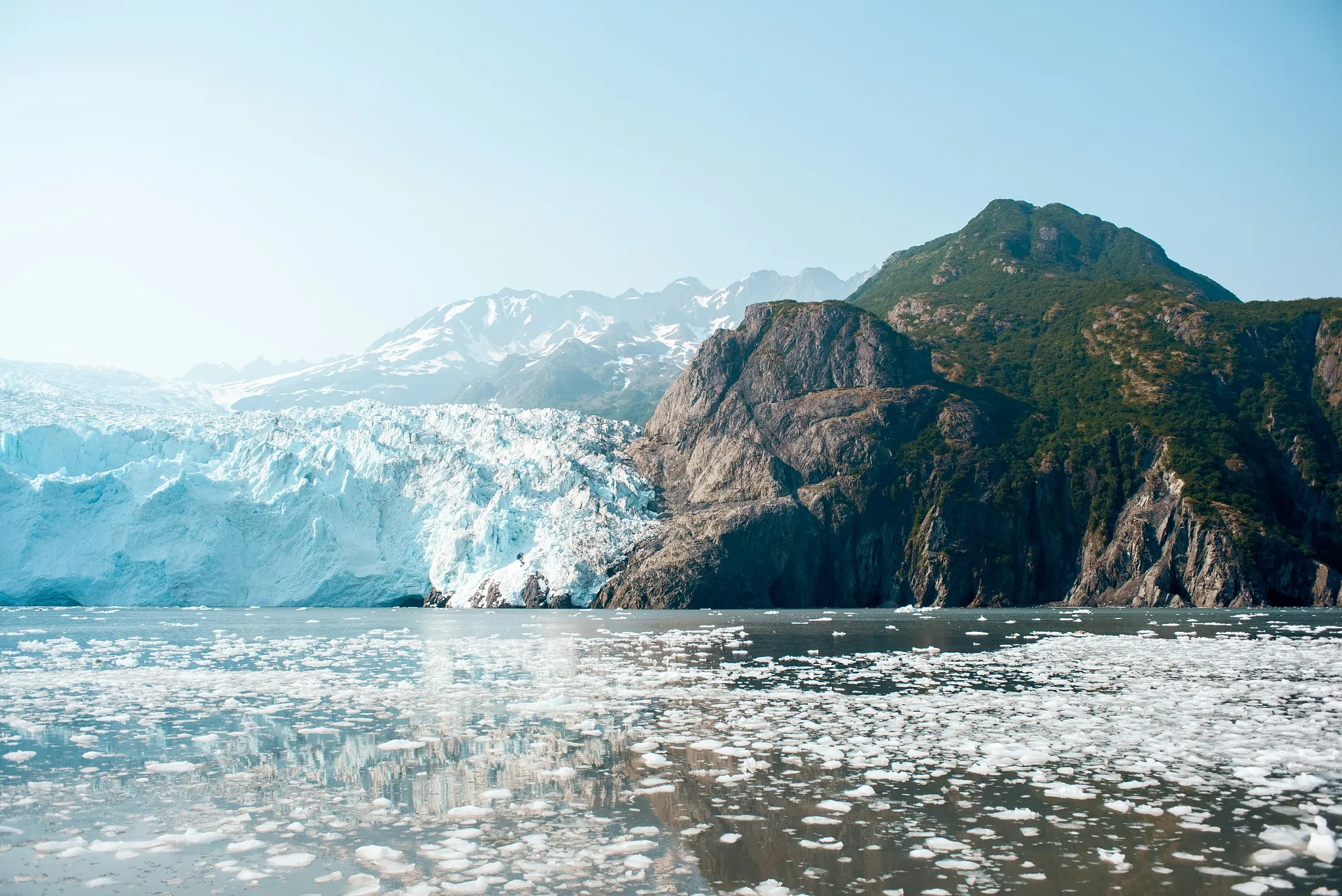 A pristine view of the majestic glacier, with ice floes dotting the serene waters below.