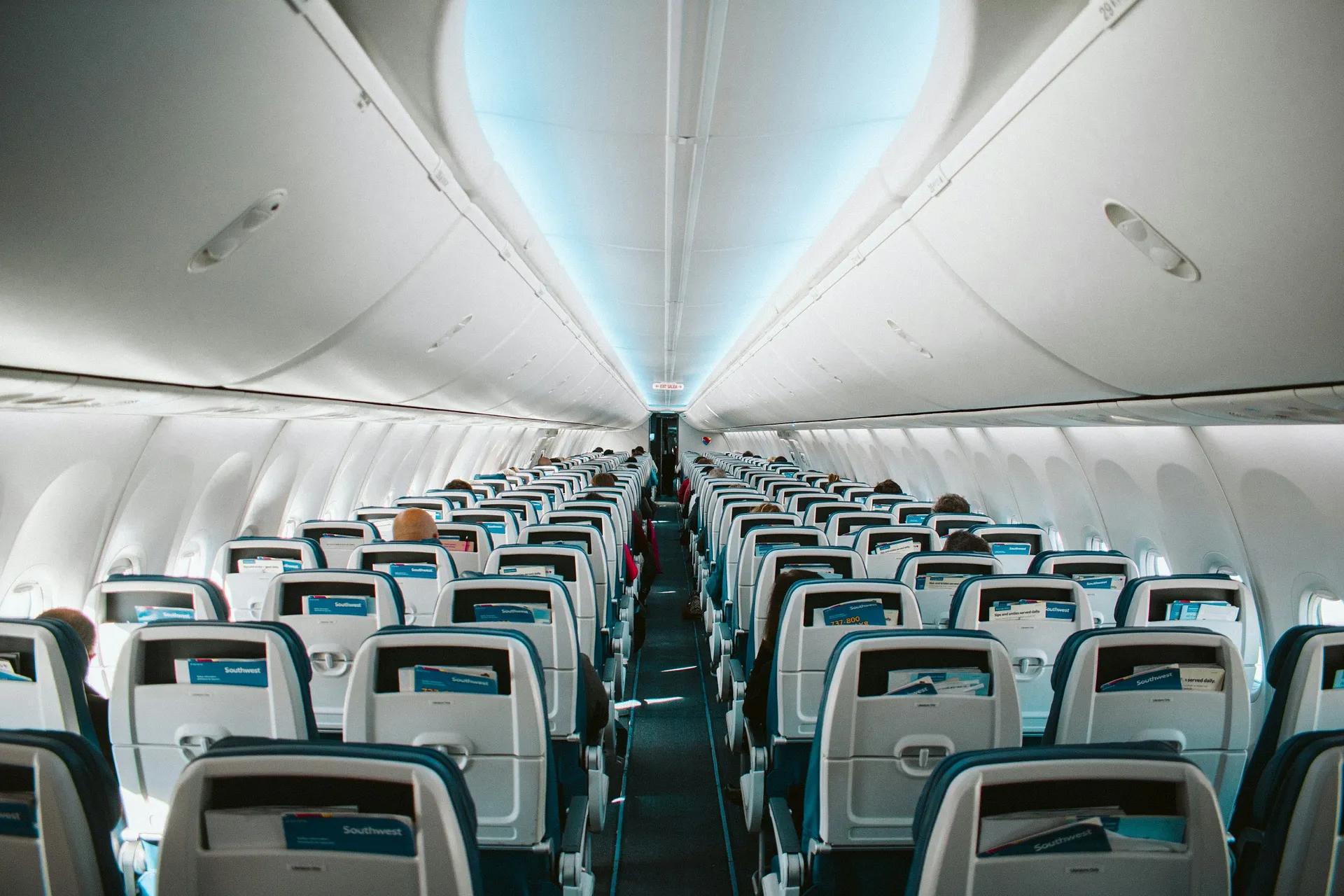Passengers sit inside a Southwest Airlines aircraft cabin.