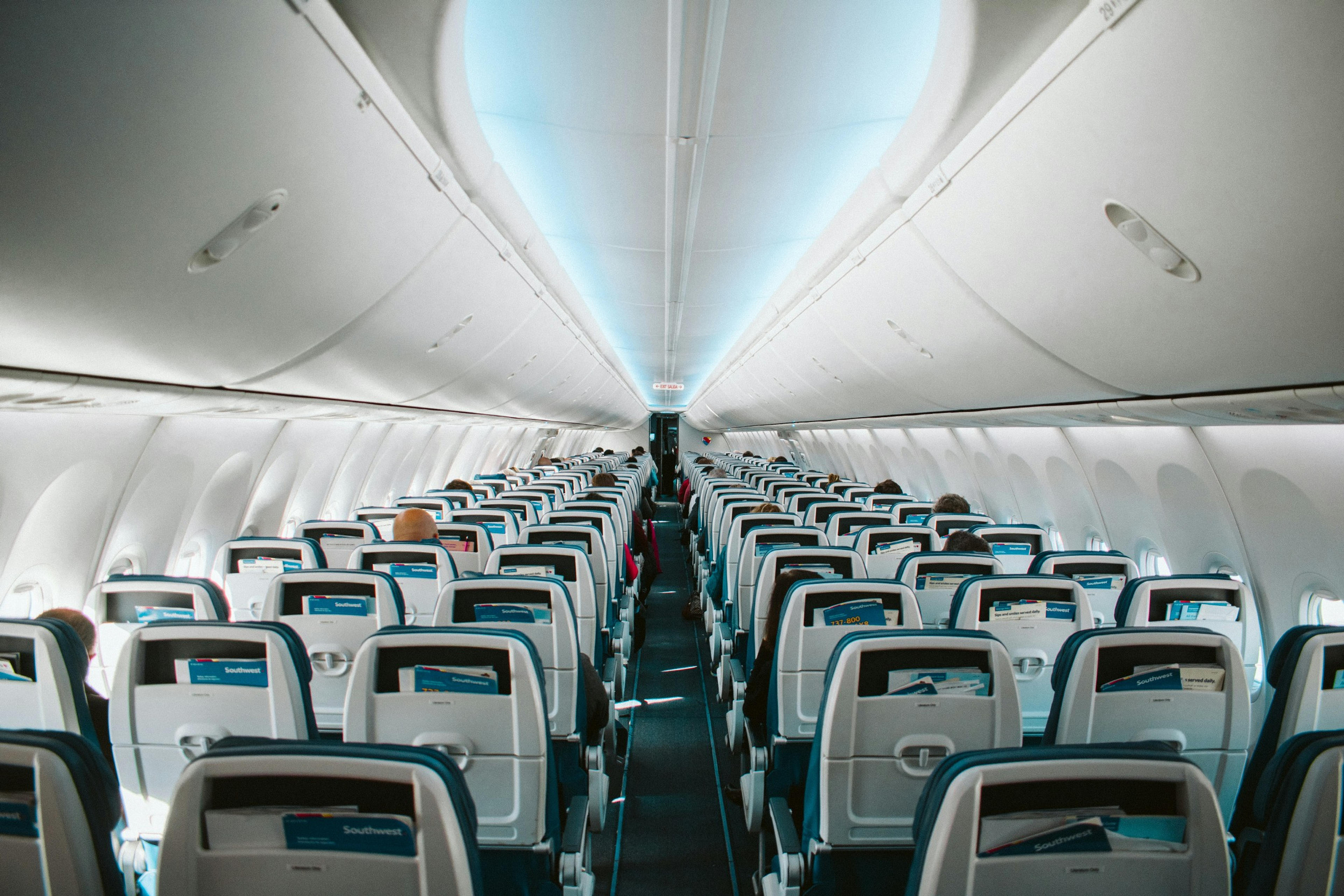 Passengers sit inside a Southwest Airlines aircraft cabin.