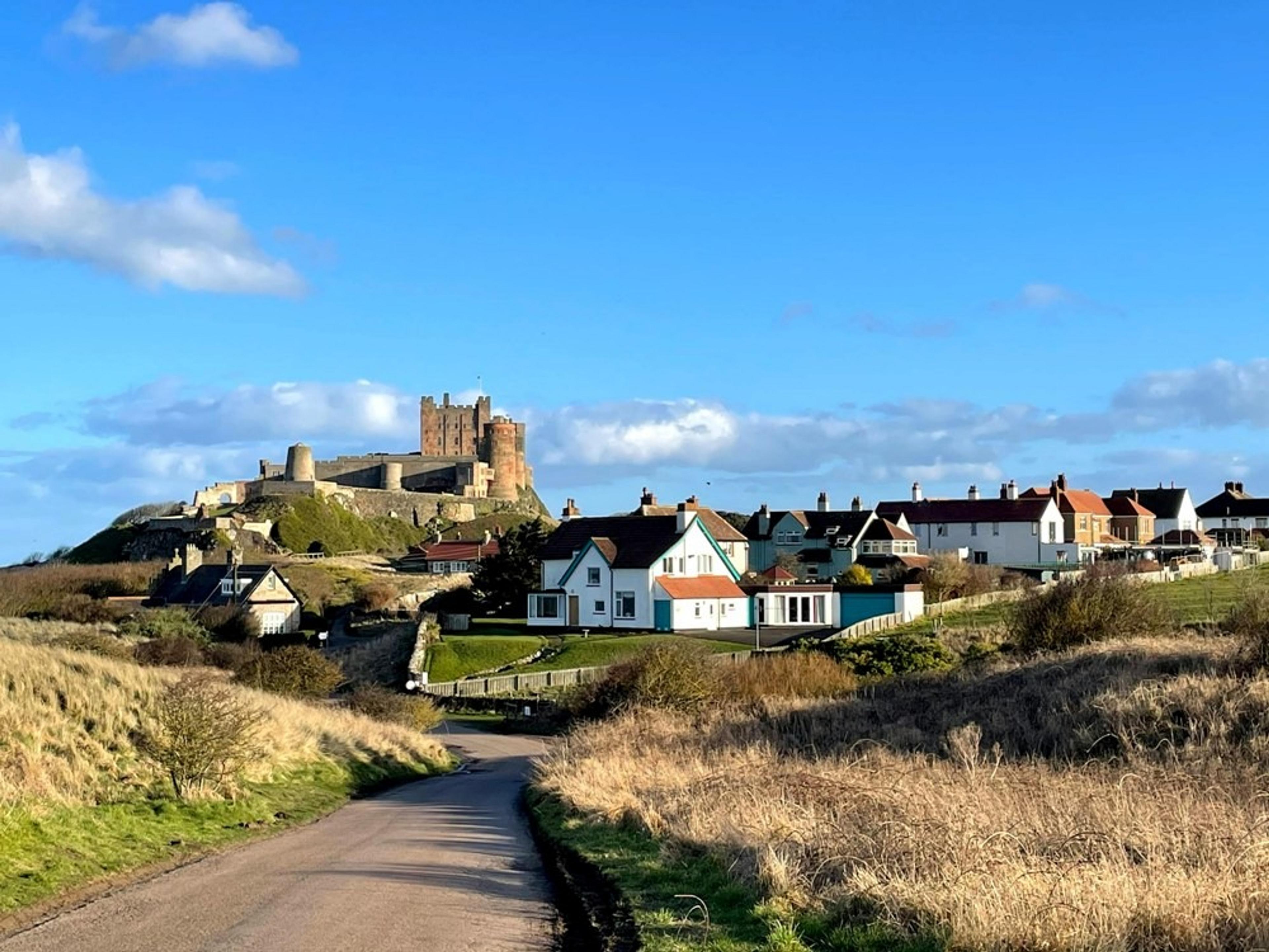 Town of Bamburgh with castle perched on the hill