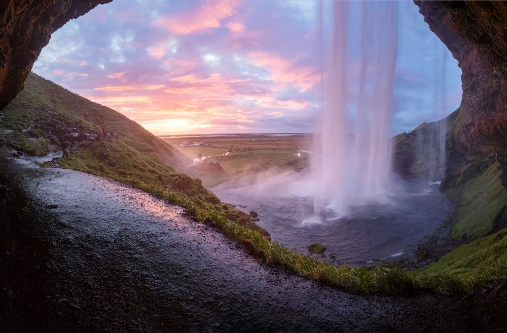 Looking out from inside a cave, behind a waterfall