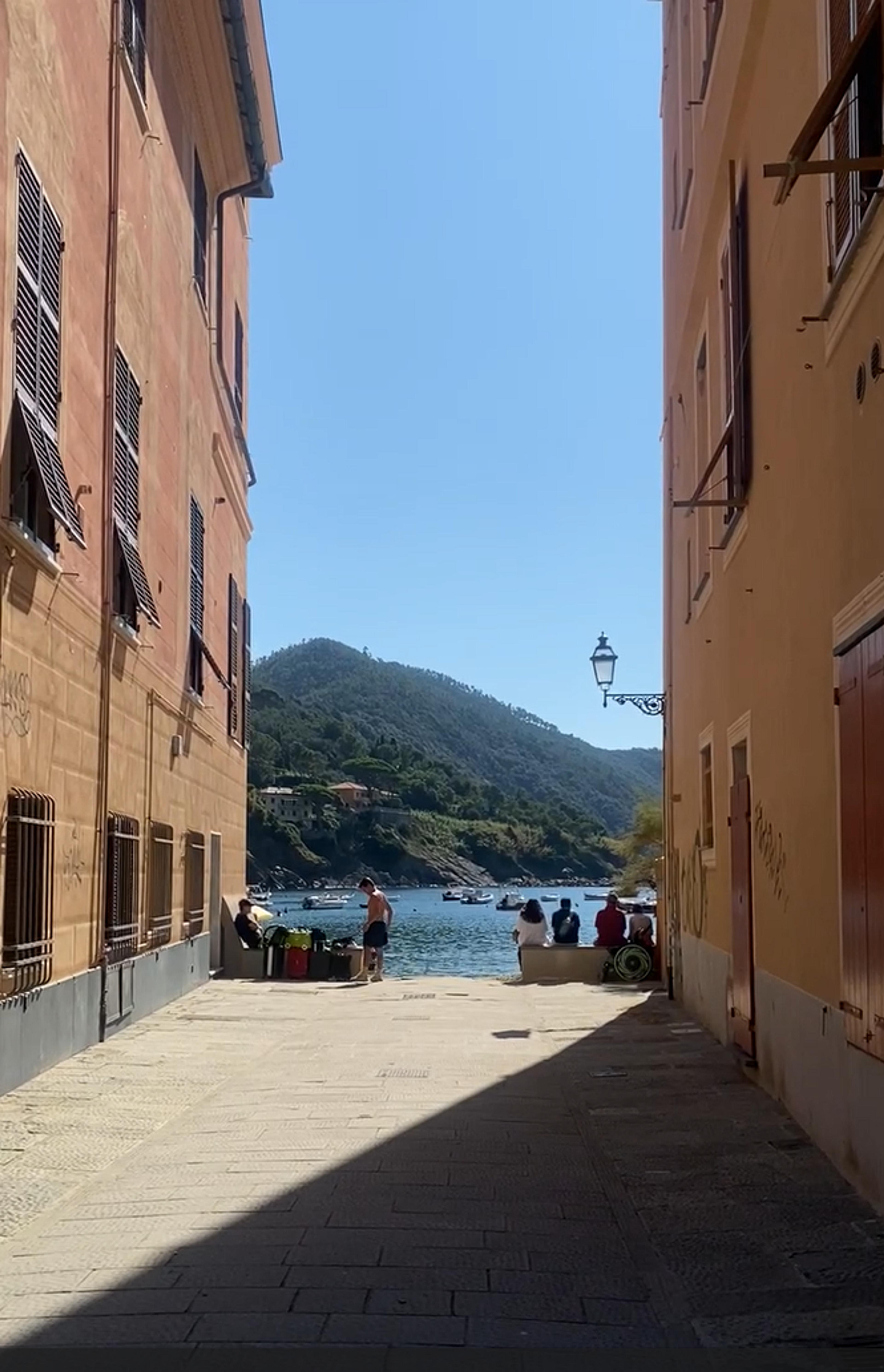 A narrow street opens to a view of Bay of Silence
