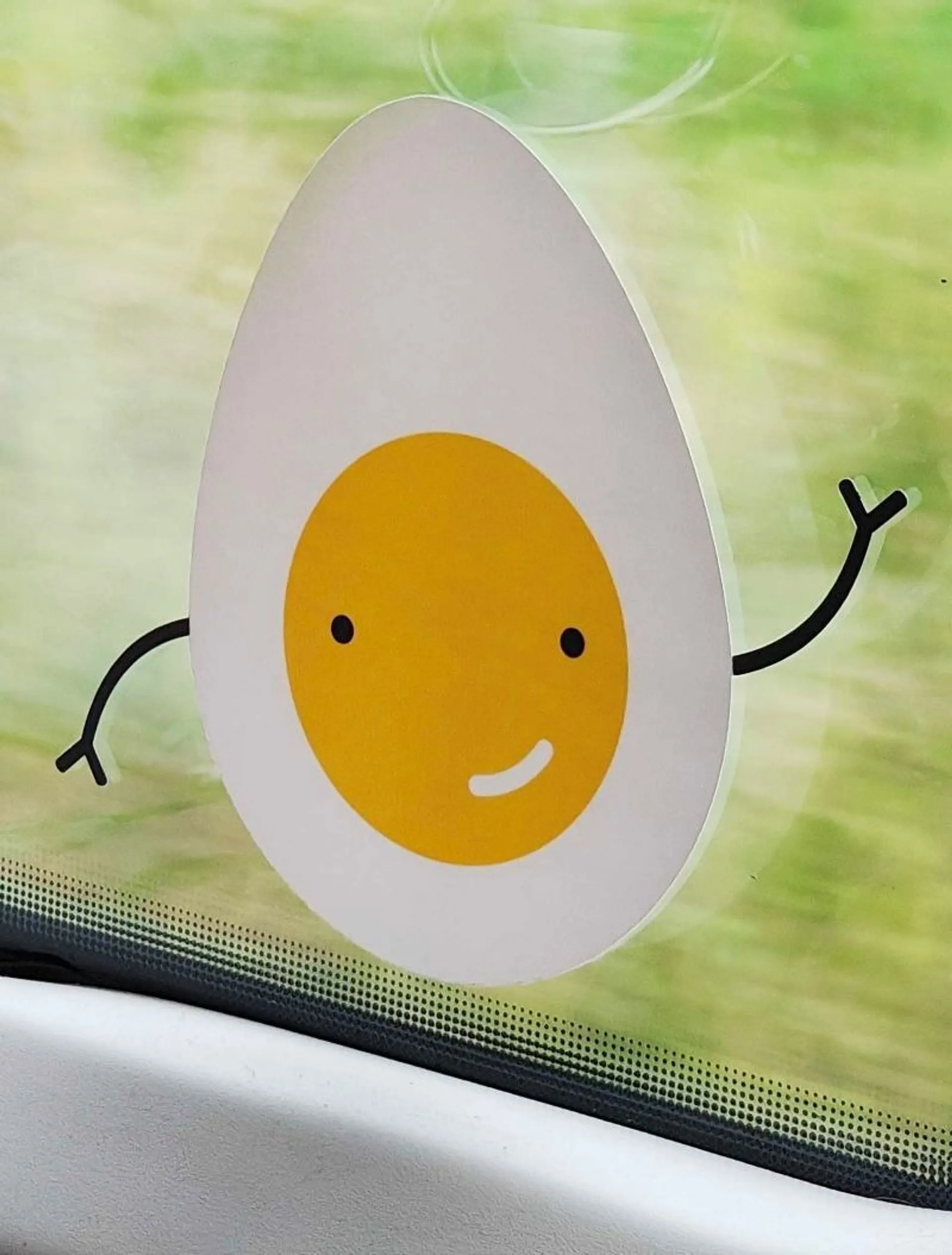 Cartoon egg sticker smiling and waving on the window of a Lithuanian train