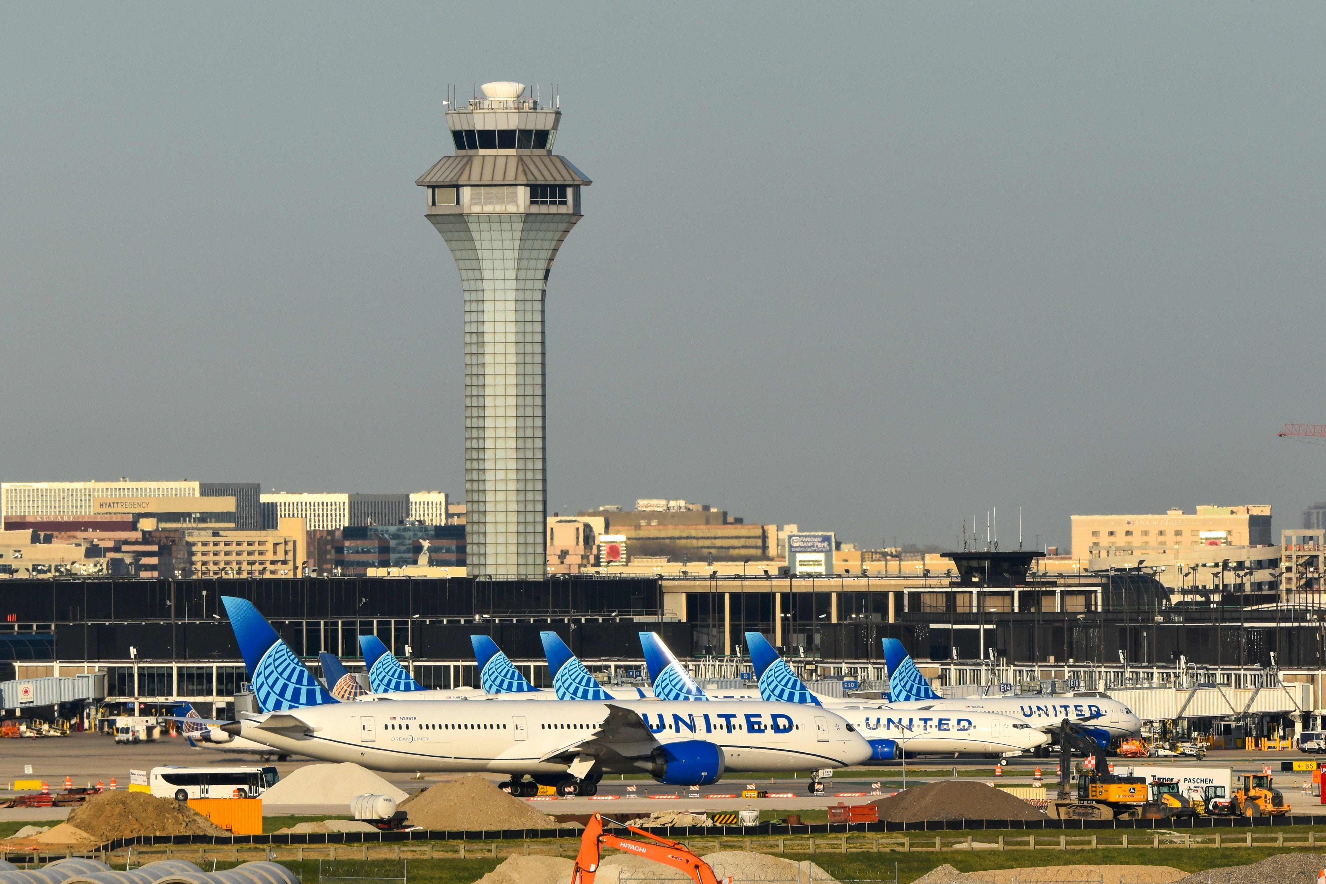 O'Hare International Airport in Chicago displays several United Airlines planes lined up near the control tower.