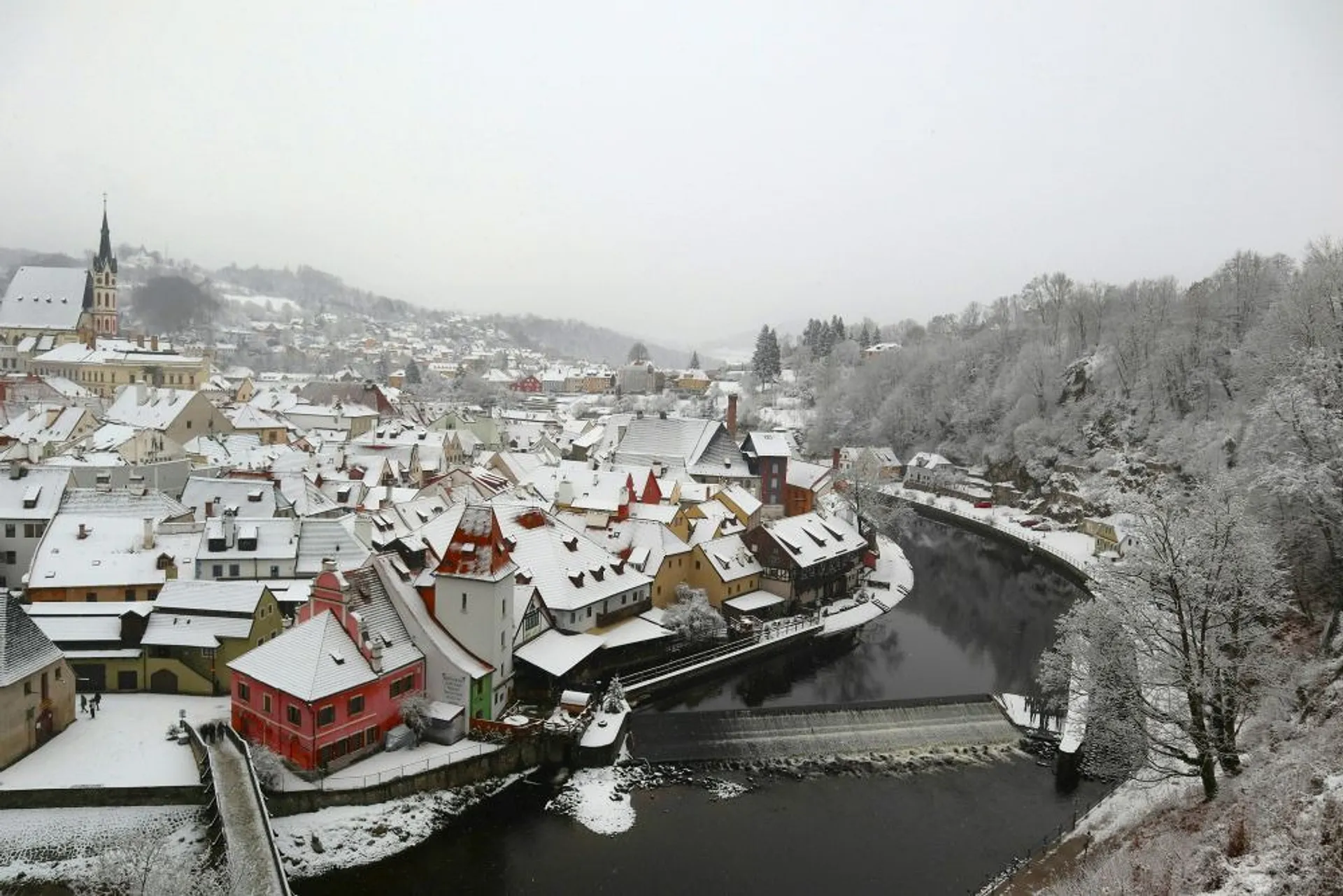 A snowy winter landscape blankets the charming town of Český Krumlov in the Czech Republic.