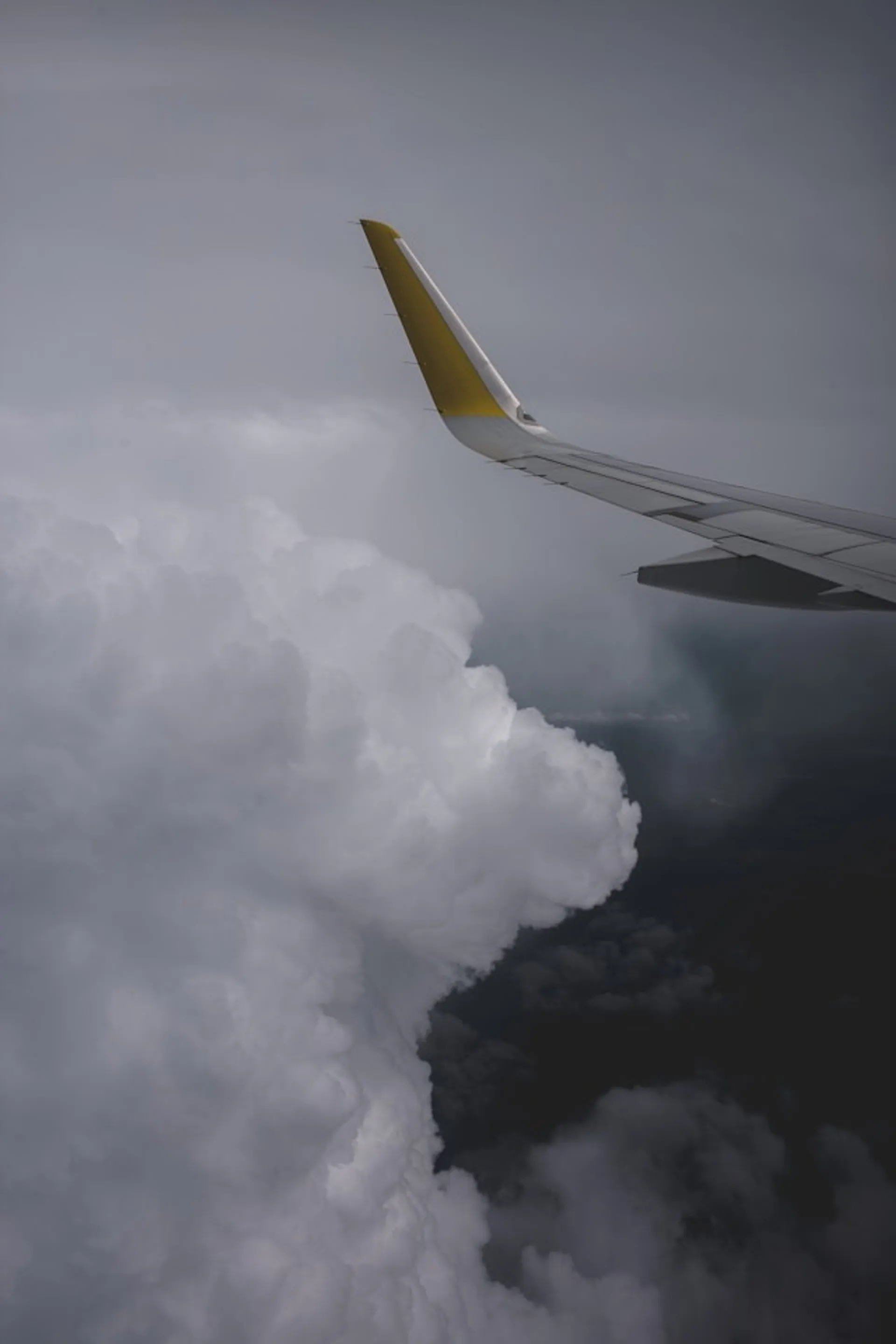 Jetliner wing soaring above a dense layer of clouds, en route to Scotland.