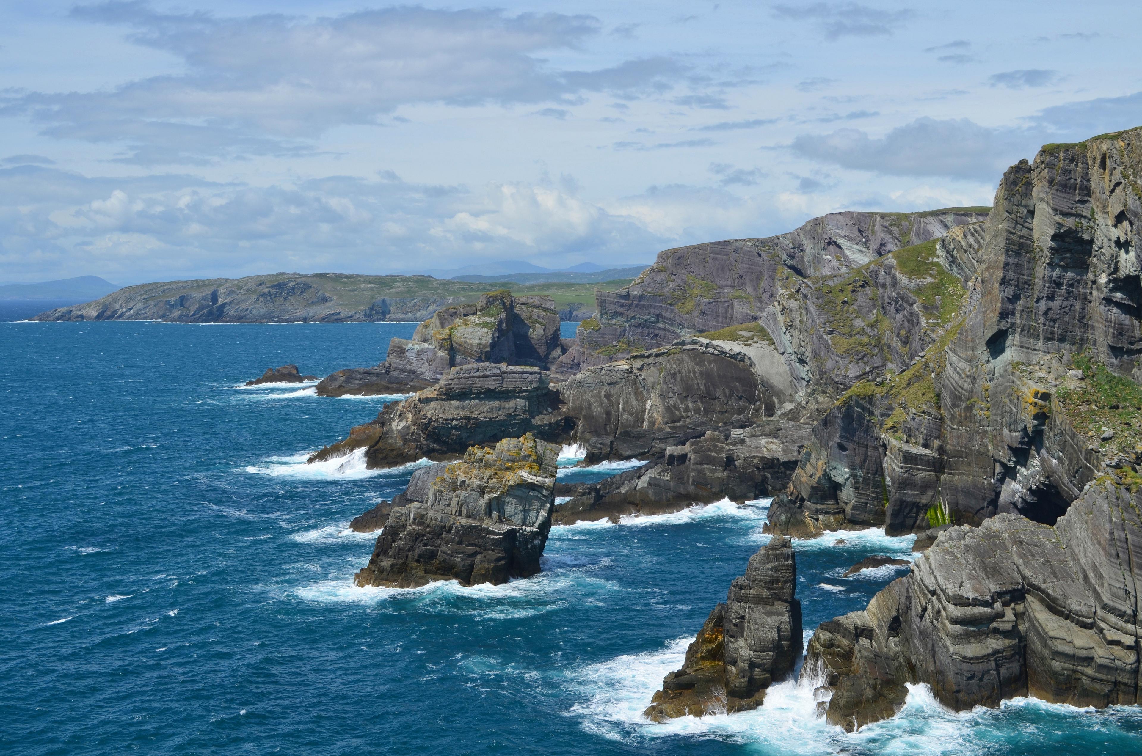 Rugged cliffs and rocky formations define the dramatic coastline of Mizen Head in County Cork, Ireland.