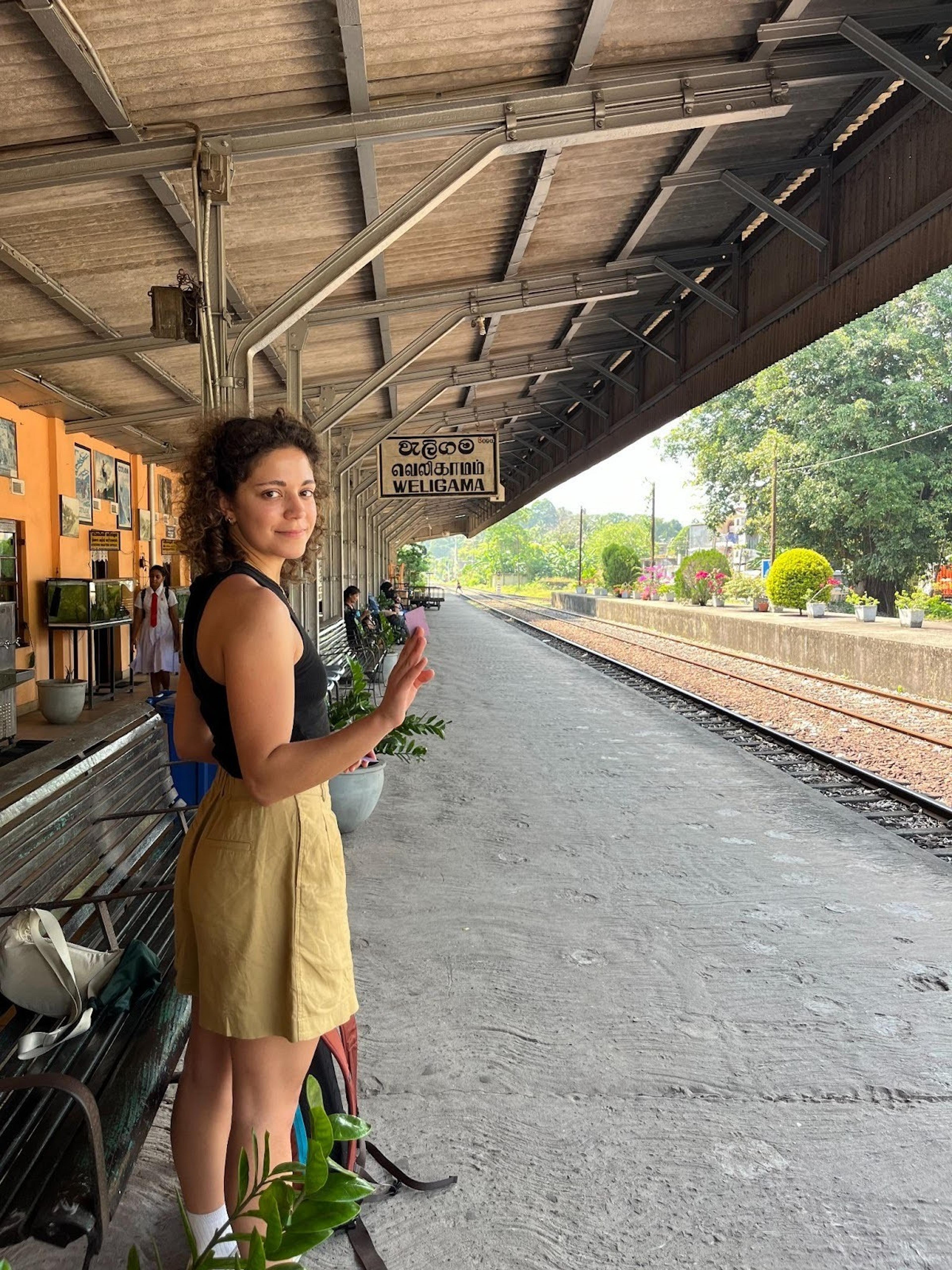 A person stands on the platform at Weligama railway station in Sri Lanka.