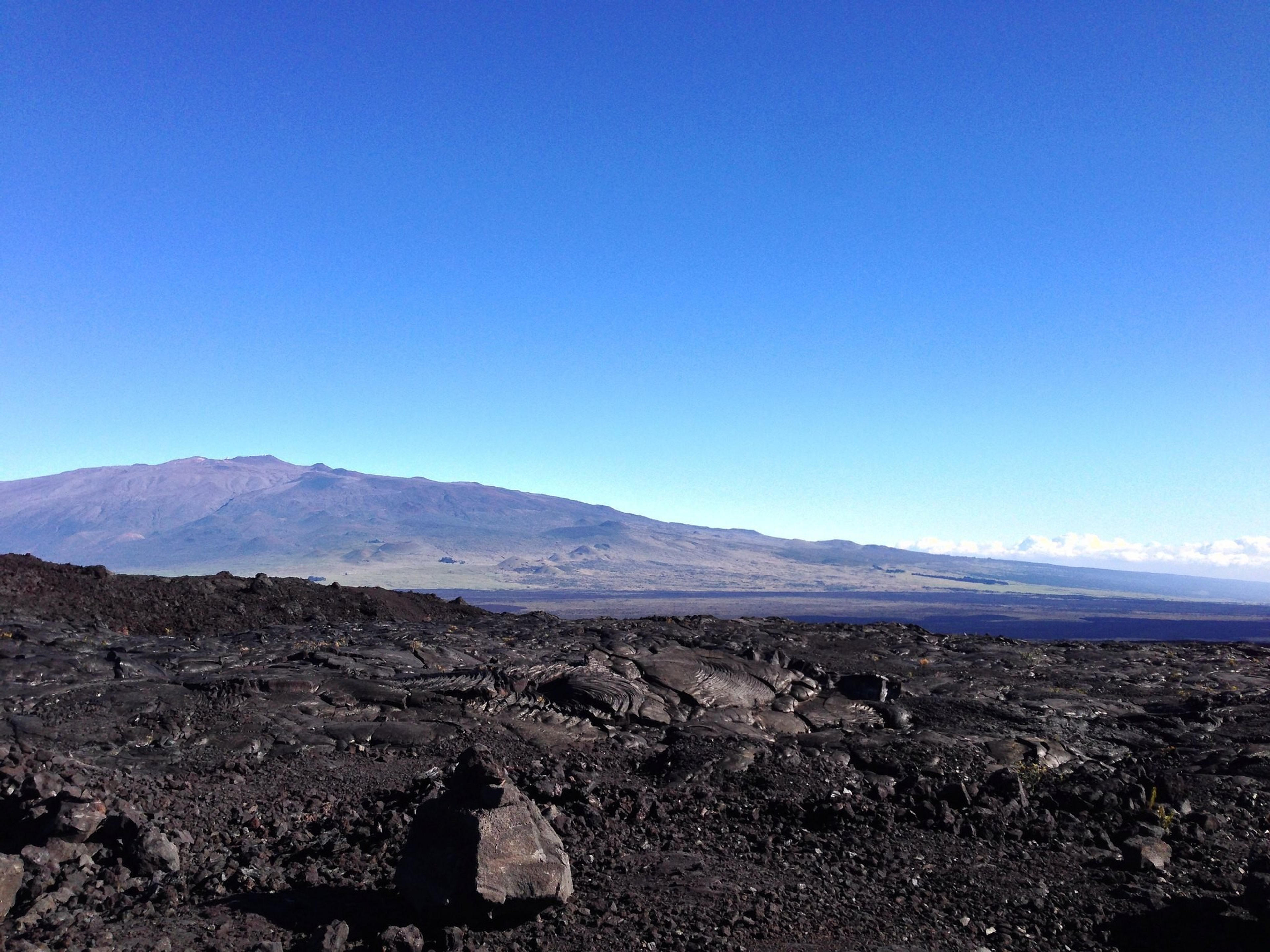 Vast volcanic rock landscape with Mauna Loa in the background on the Big Island of Hawaii.