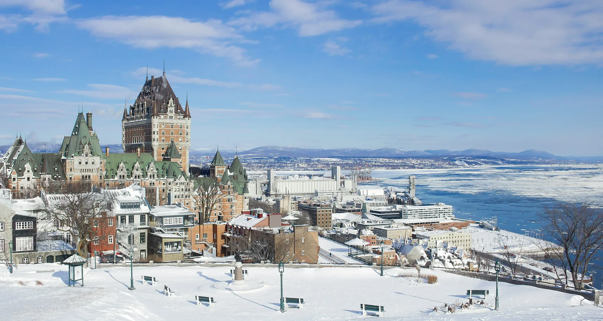 A winter view of Château Frontenac and the snowy landscape of Old Quebec City overlooking the St. Lawrence River.