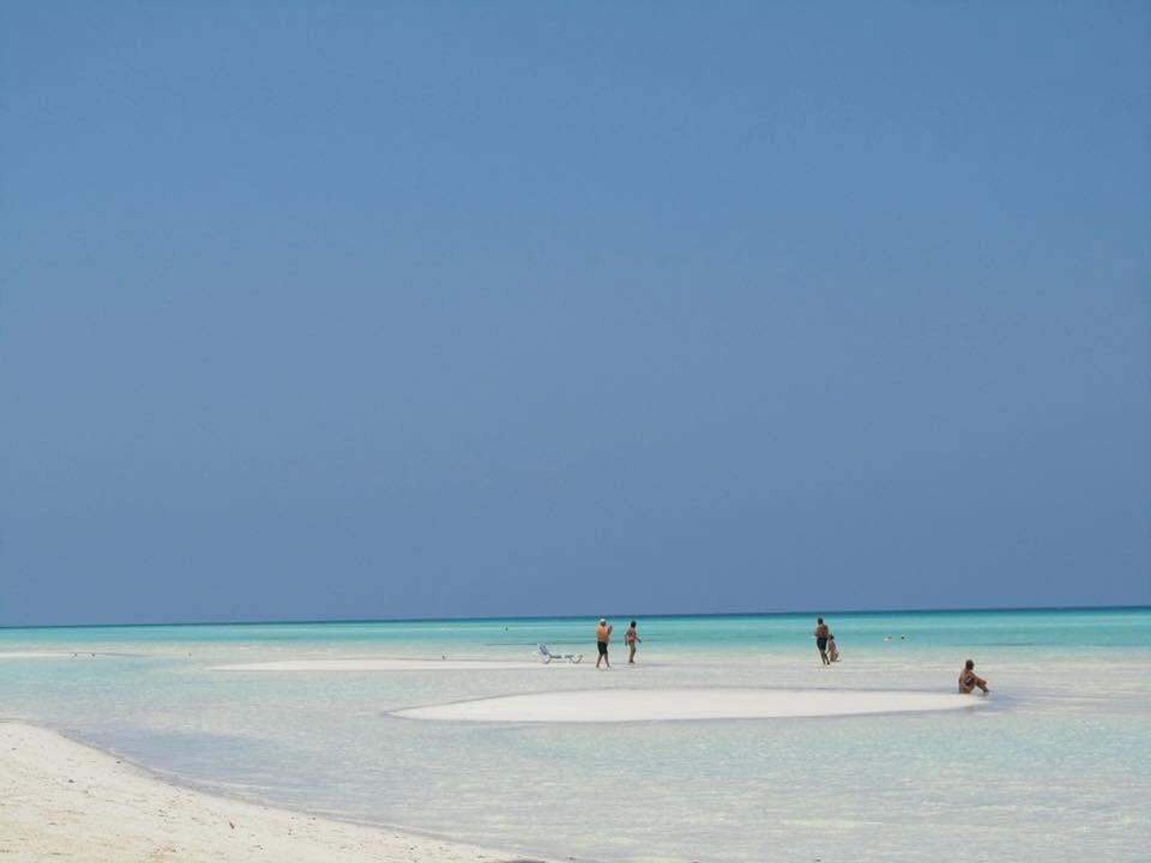 People enjoy the shallow turquoise waters and white sands of Cayo Guillermo in Cuba.