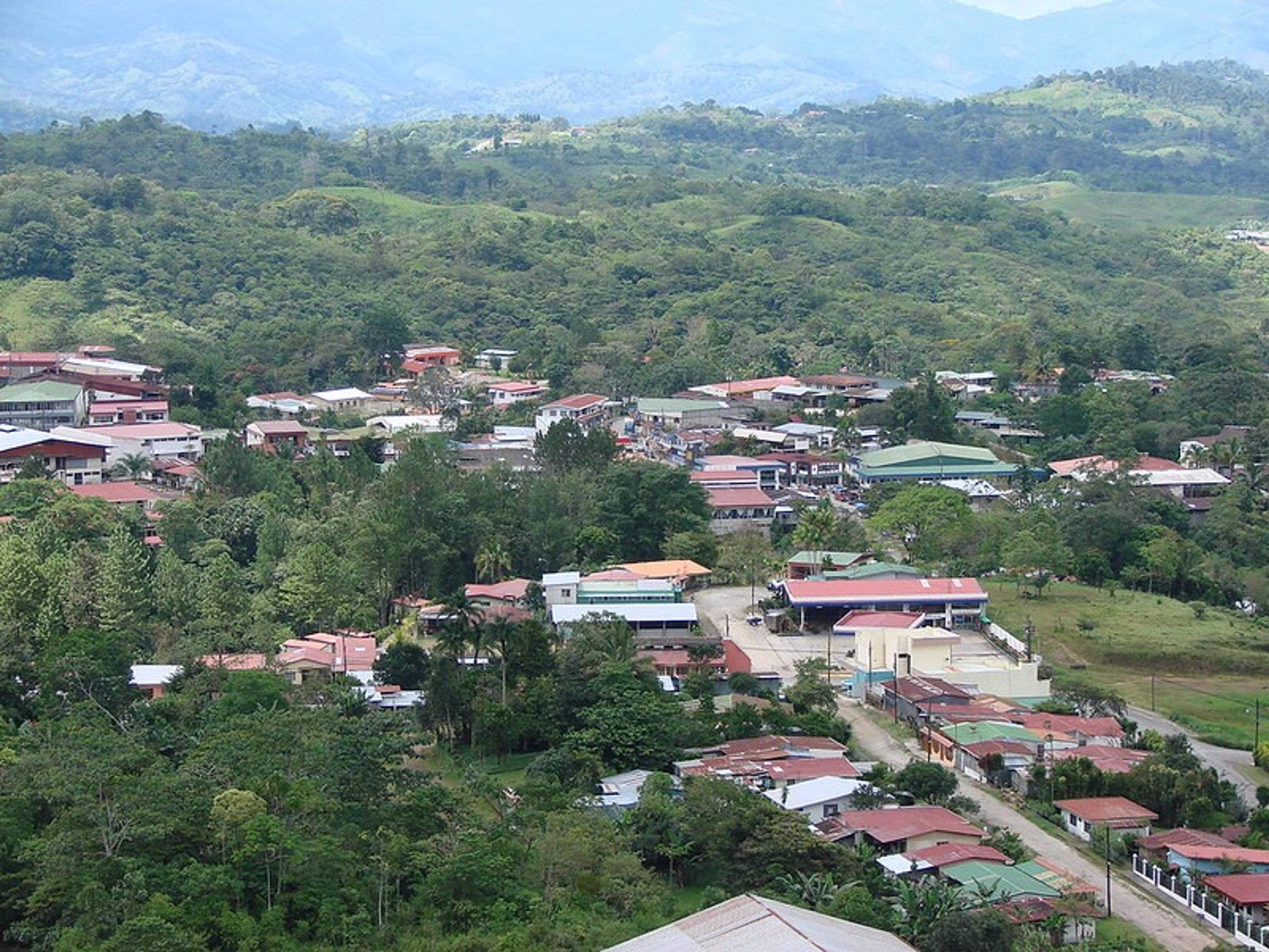 A sprawling view of San Vito, a town nestled within lush green hills in the Coto Brus province of Costa Rica.