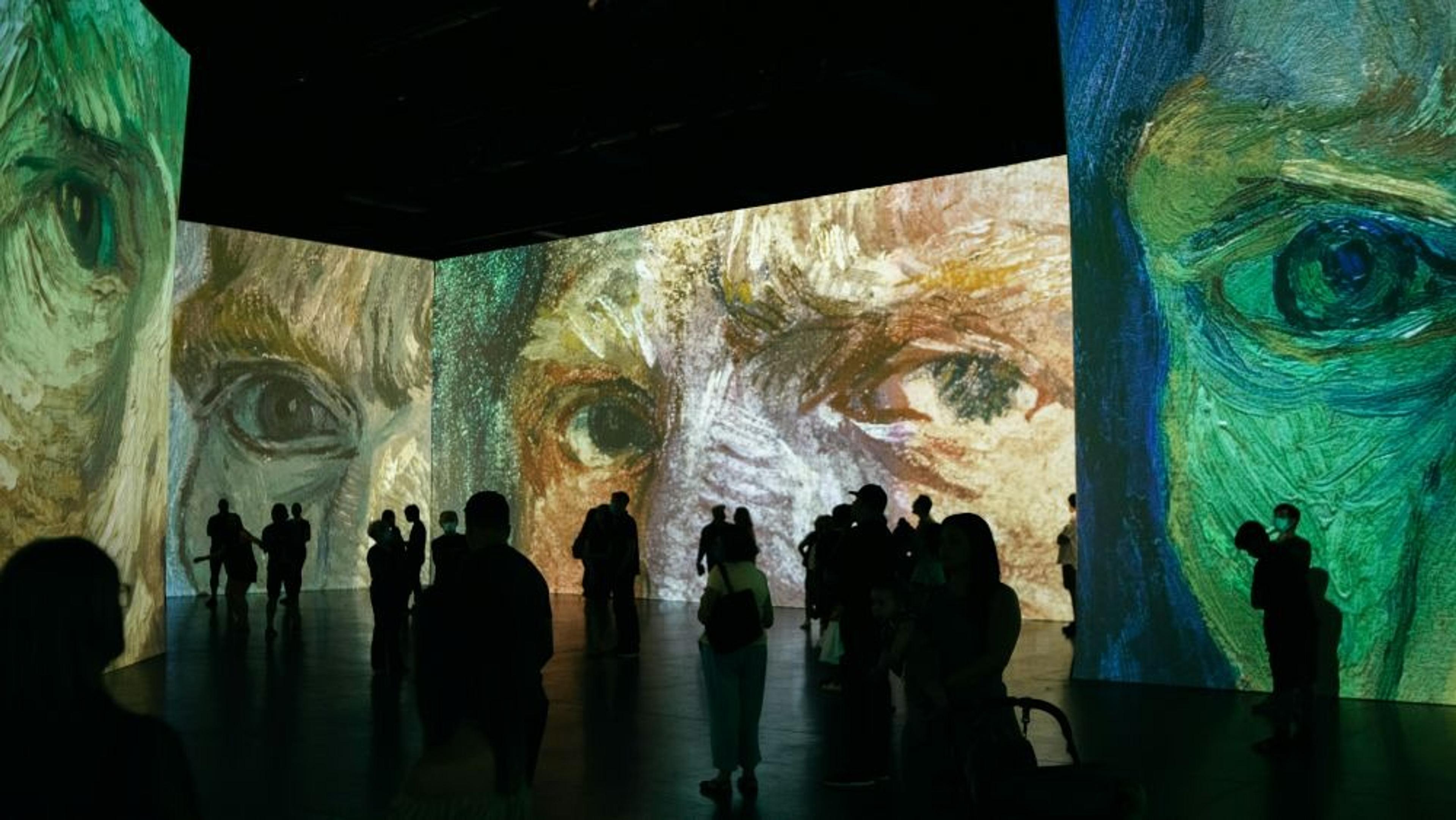 Visitors engage inside the immersive Beyond Van Gogh exhibition.