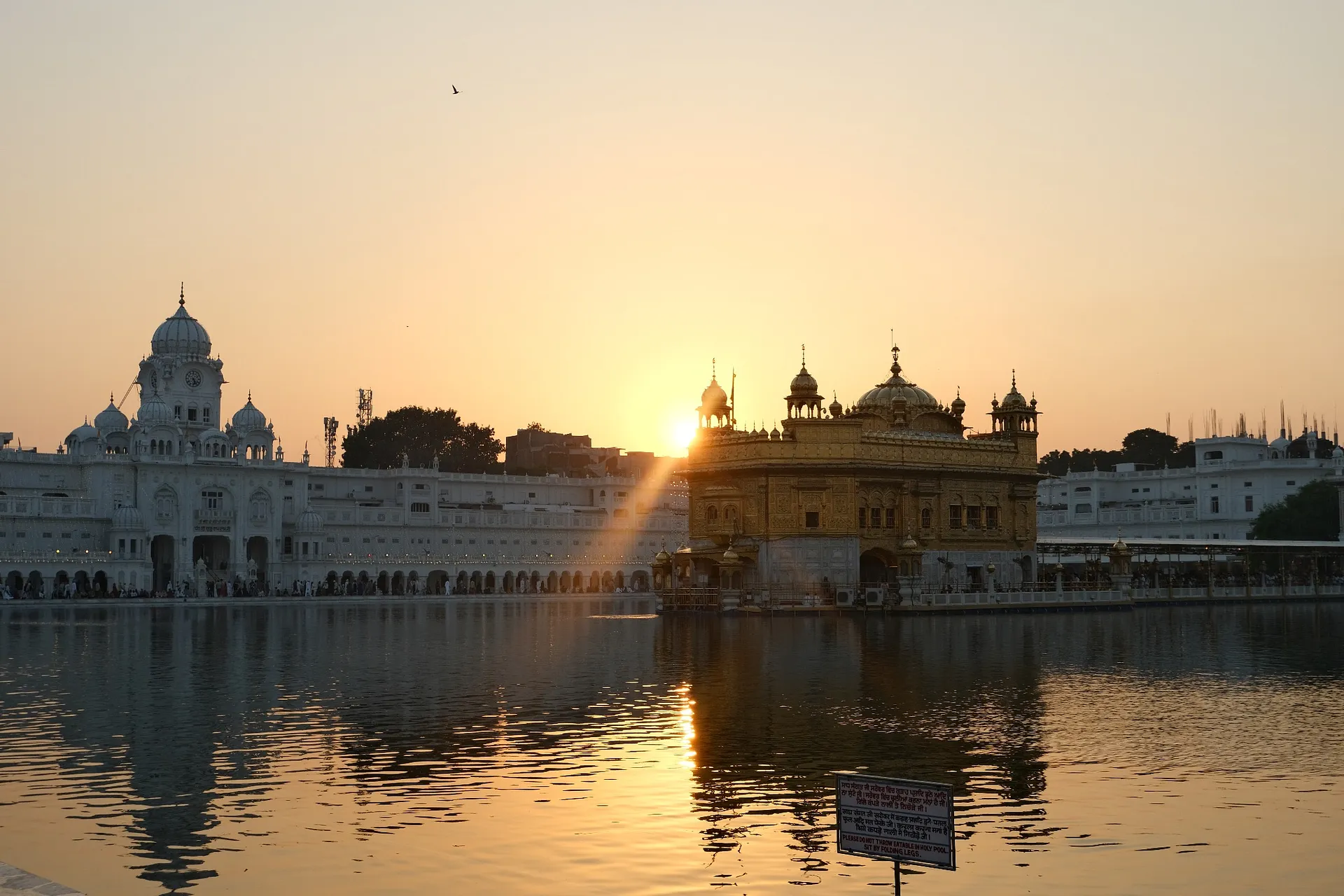 As the sun set over the sacred “Pool of Nectar” the temple’s golden coating glowed...
