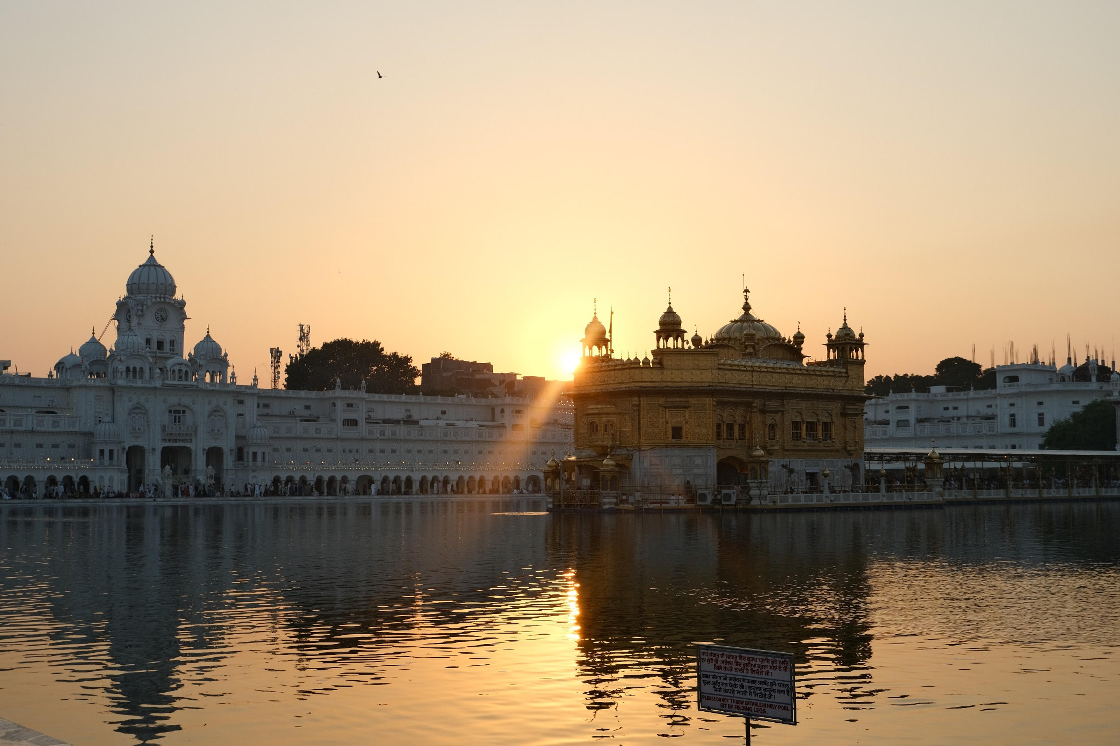As the sun set over the sacred “Pool of Nectar” the temple’s golden coating glowed...